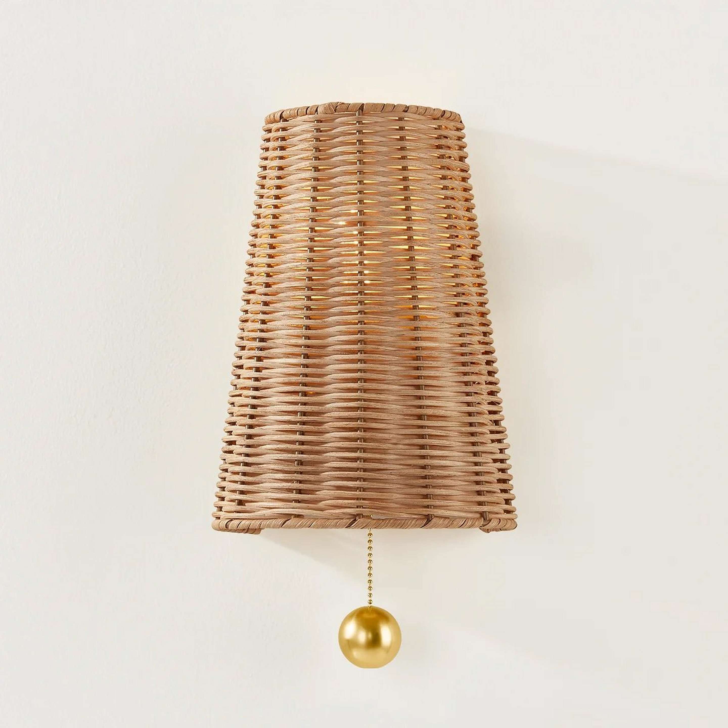 A Nyala Sconce with Brass / Natural Rattan color