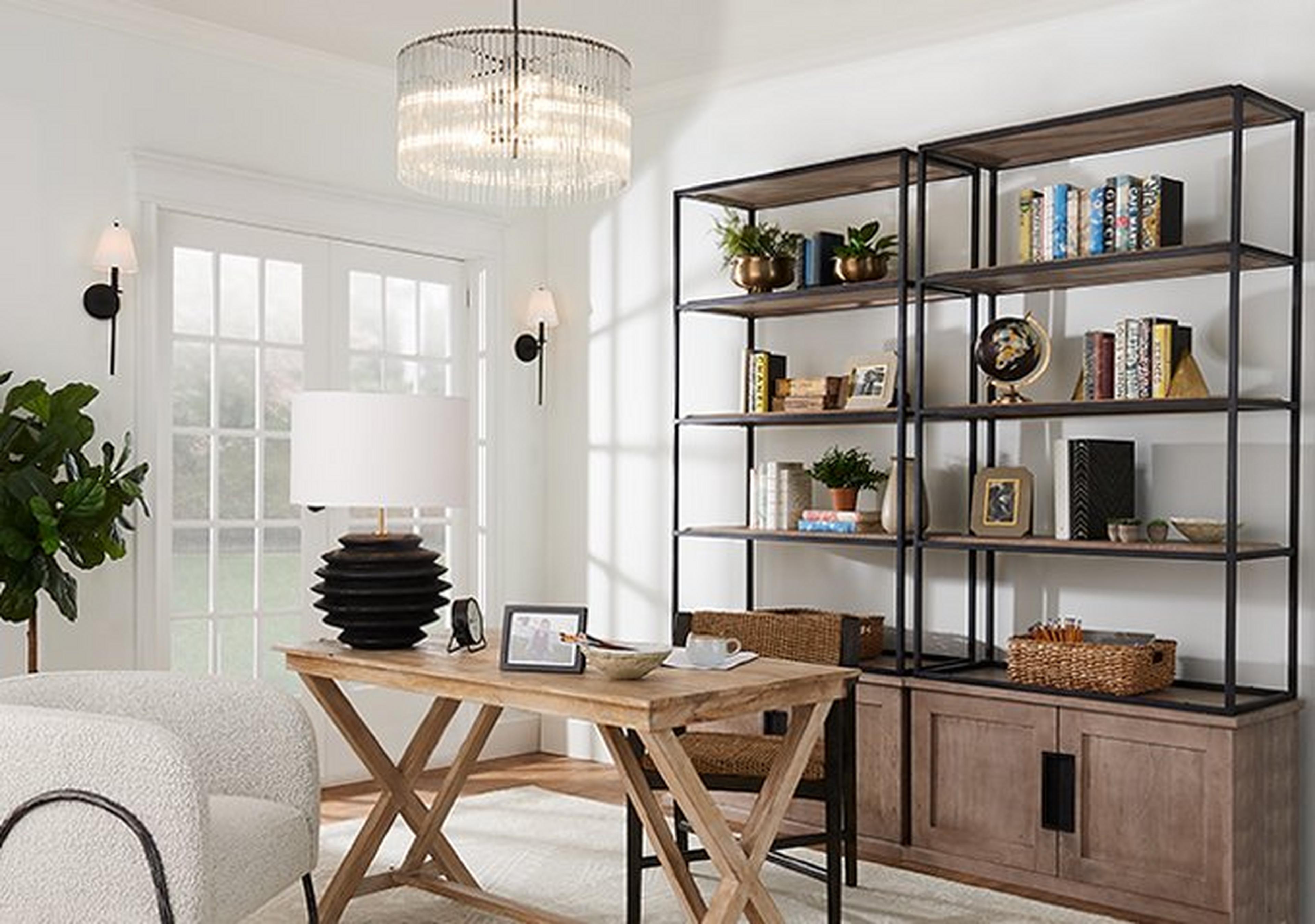 Home office with glass chandelier and shelving