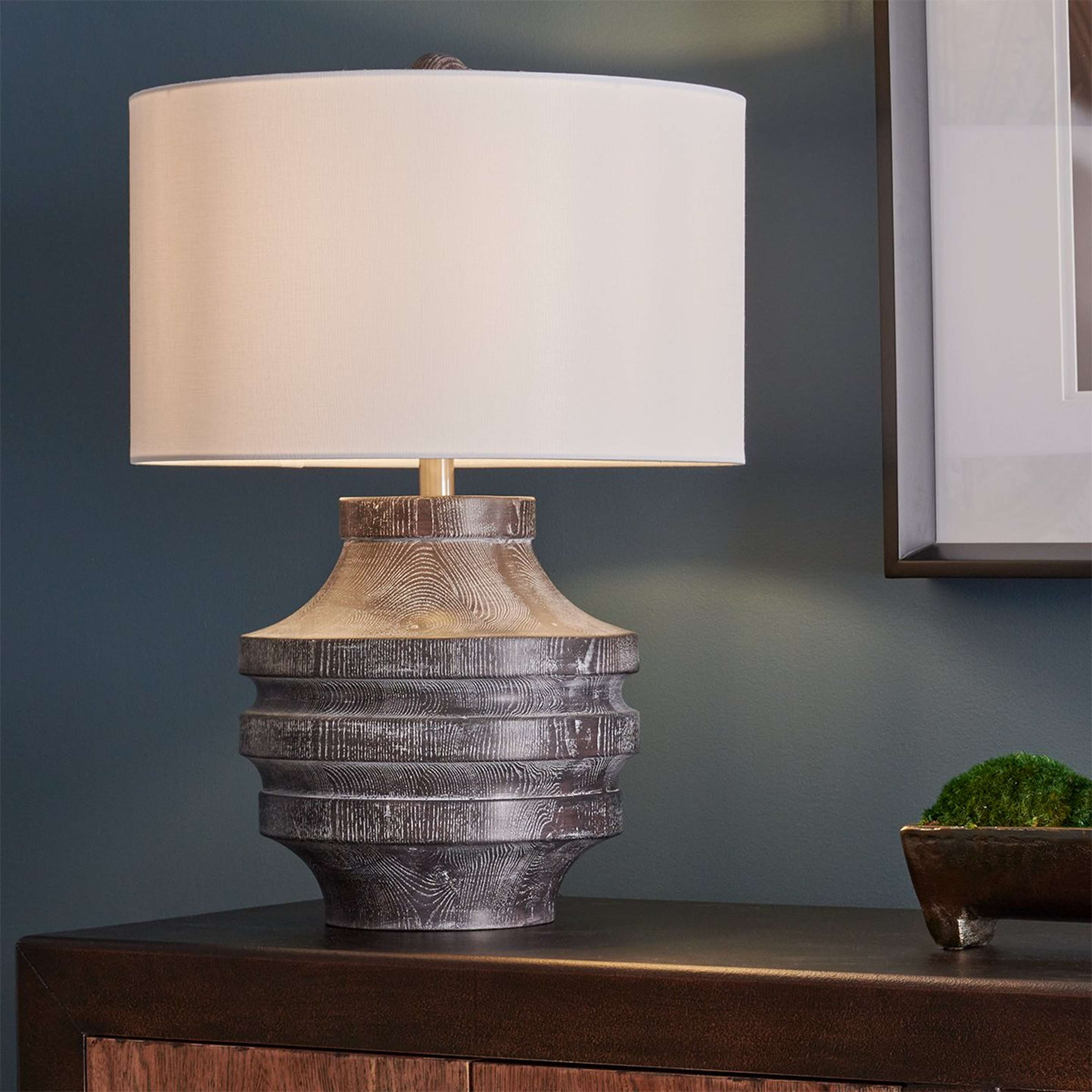 A Tocon Table Lamp with Cerused Black Faux Wood color