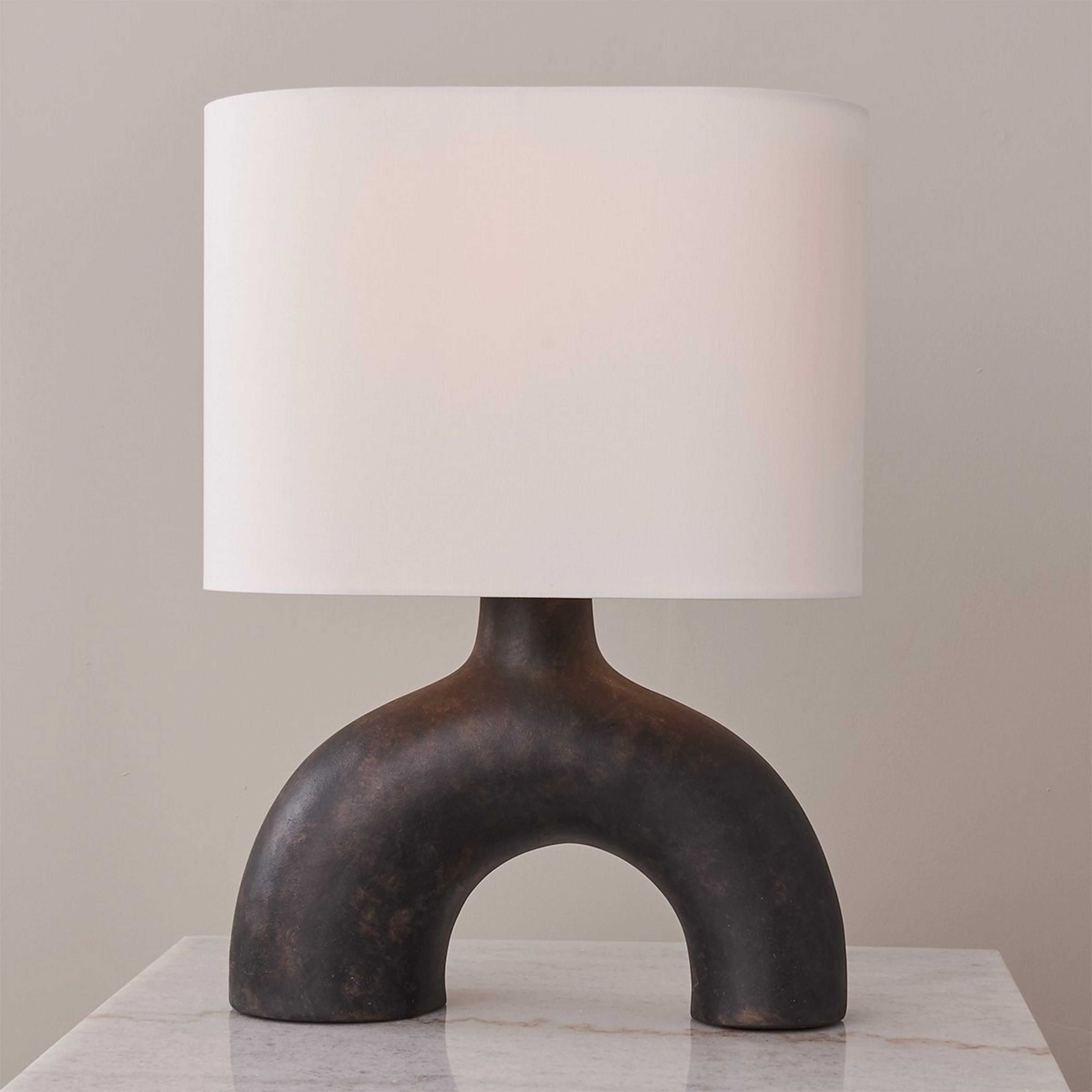 A Dissolving Oval Table Lamp with Textured Warm Black / White color
