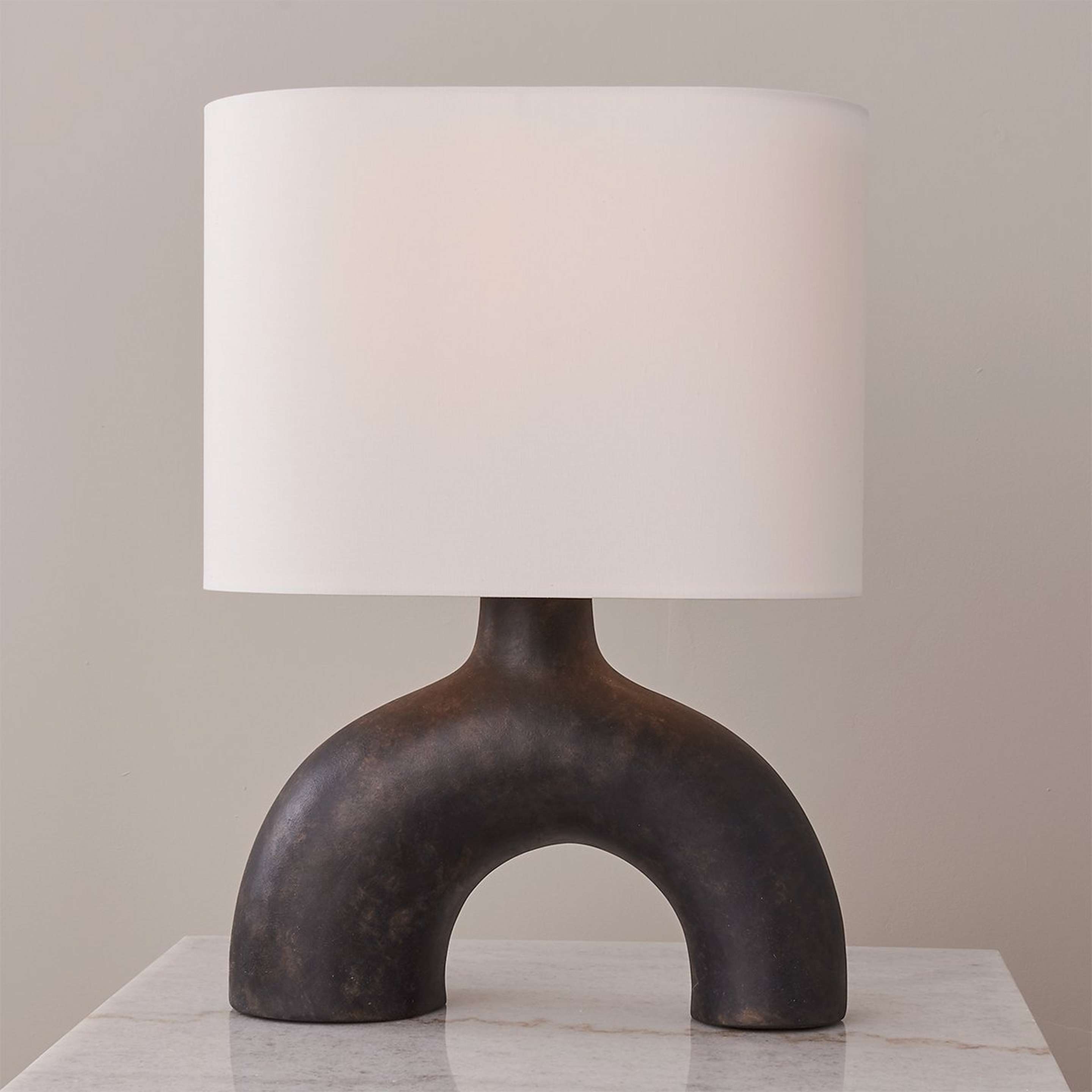 A Dissolving Oval Table Lamp with Textured Warm Black / White color