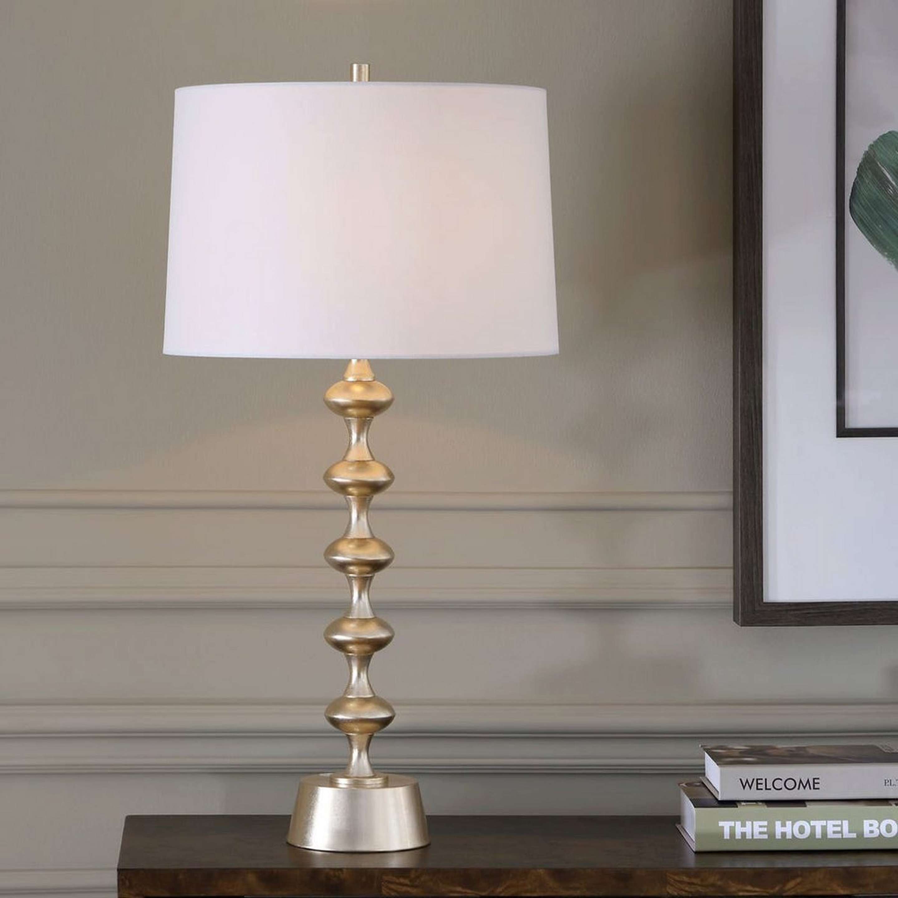 A Navasota Table Lamp with Brass / White color