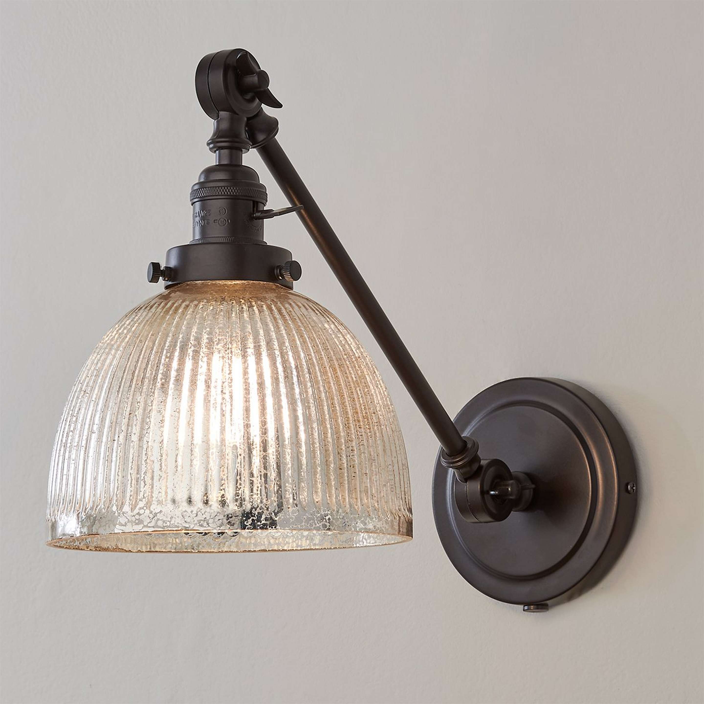 A Mercury Glass Dome Swivel Swing Arm with Oil Rubbed Bronze color