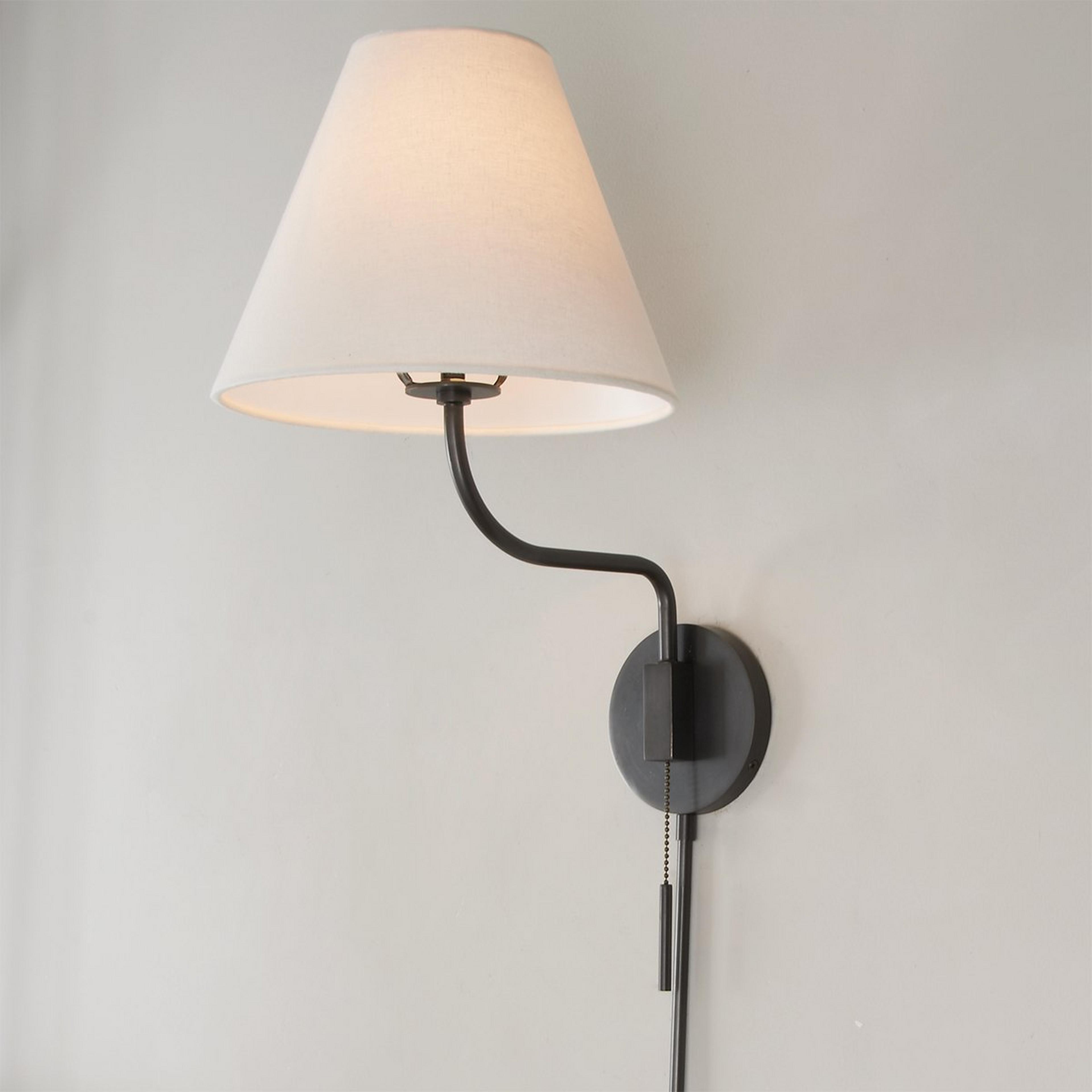 A Transitional Swing Arm Sconce with Bronze color