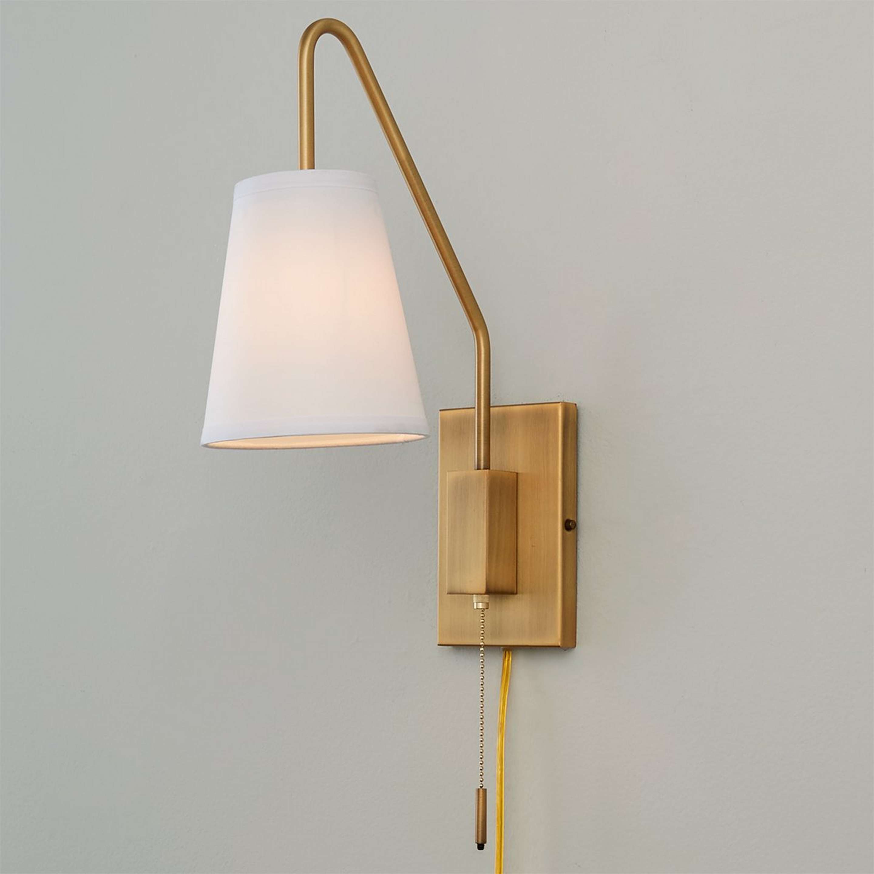 A Modern Sleek Swing Arm Sconce with Warm Brass color