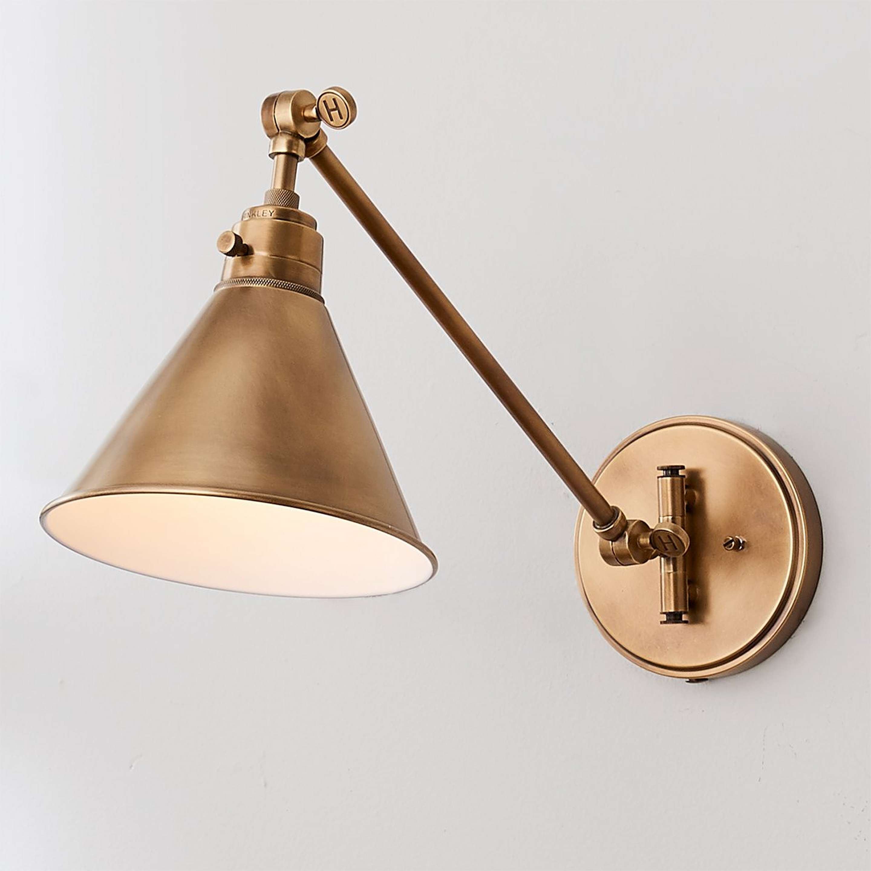 A Cyrus Straight Swing Arm Sconce - Metal Shade with Aged Brass color