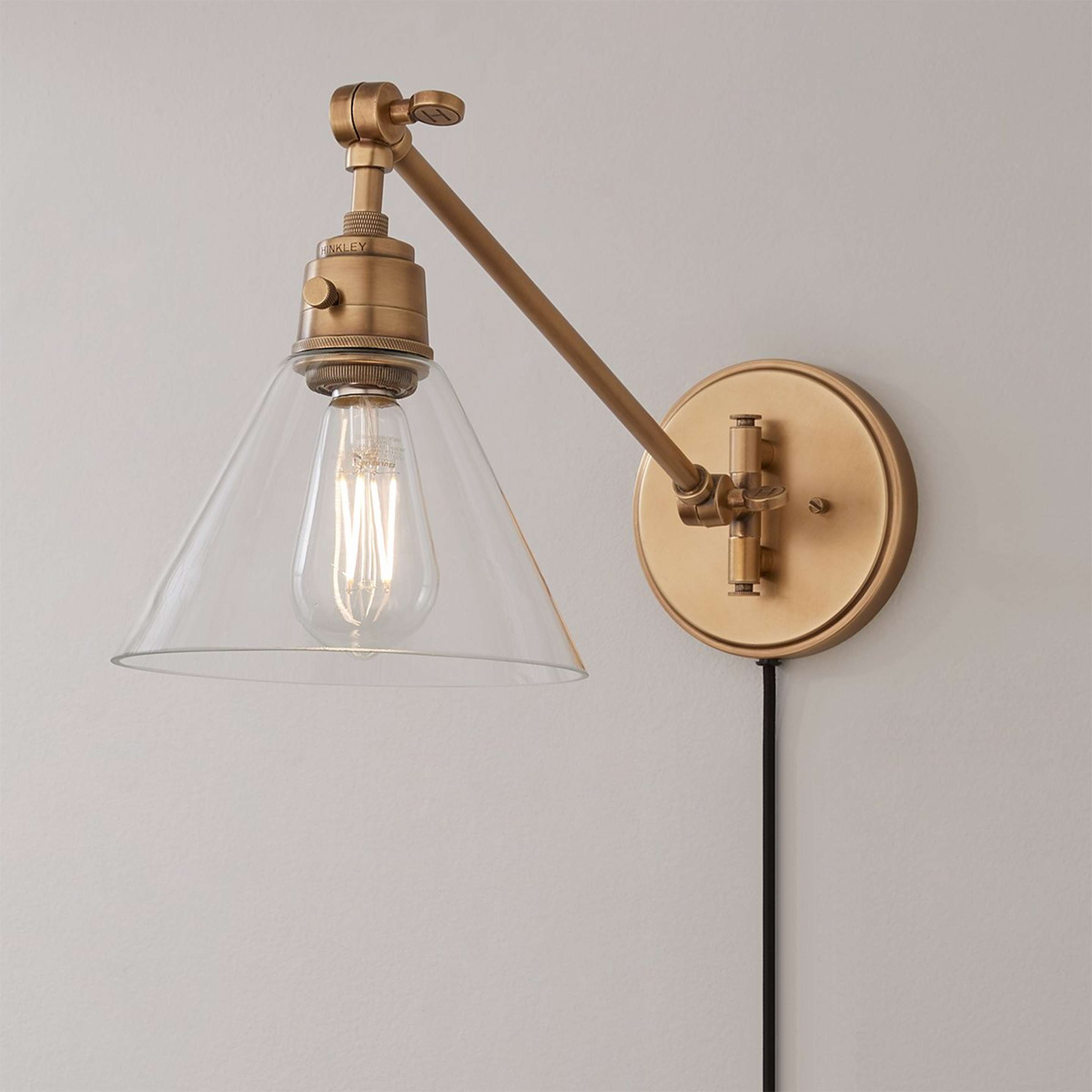 A Cyrus Straight Swing Arm Sconce - Glass Shade with Aged Brass / Clear Glass color