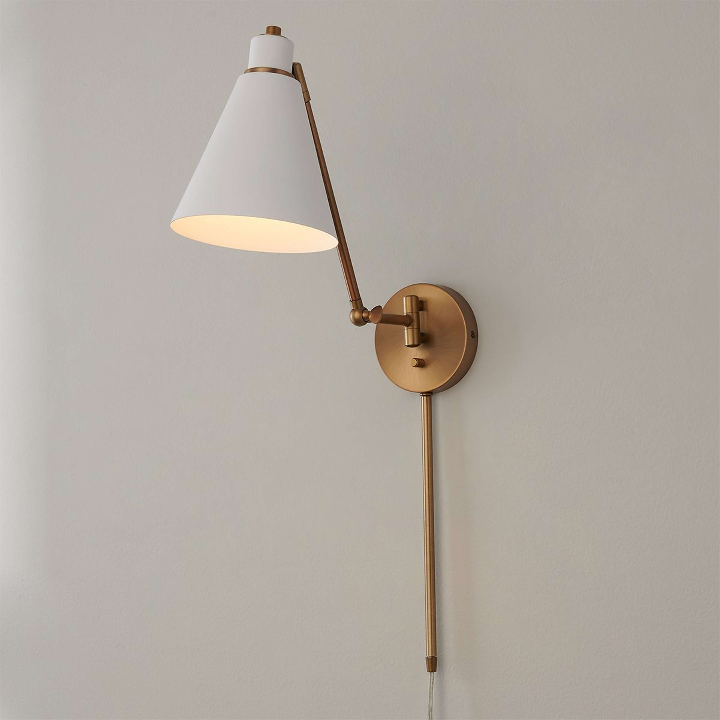 A Jenovia Swing Arm Sconce with Aged Brass / White color