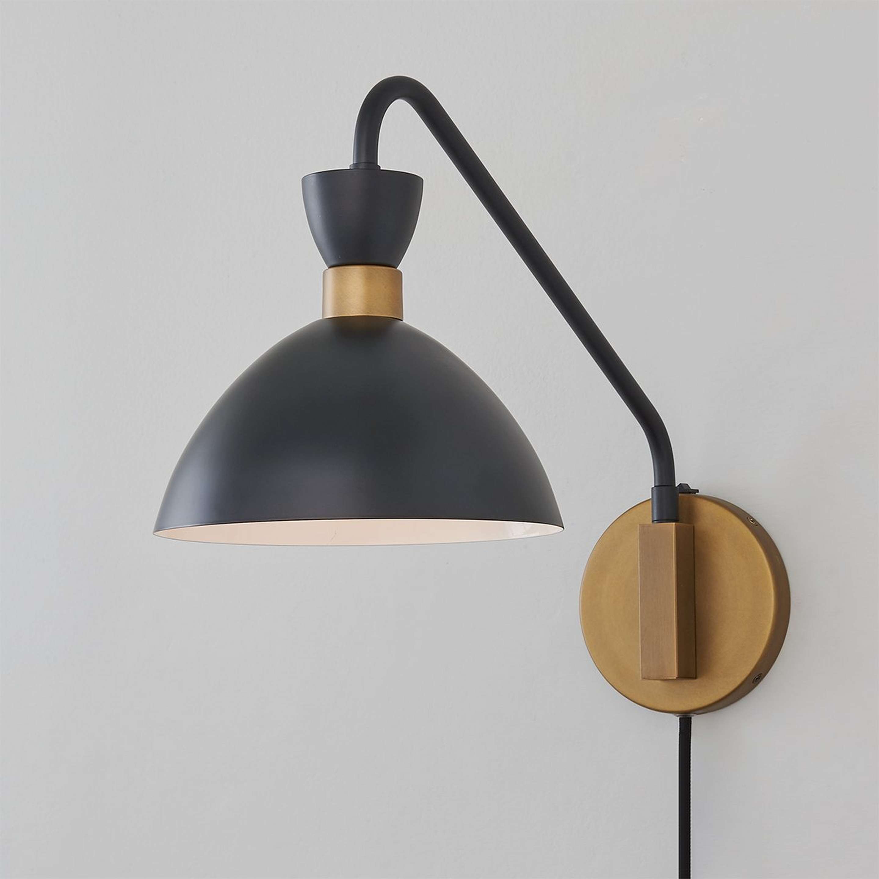 A Arendelle Metal Swing Arm Sconce with Brass / Black color