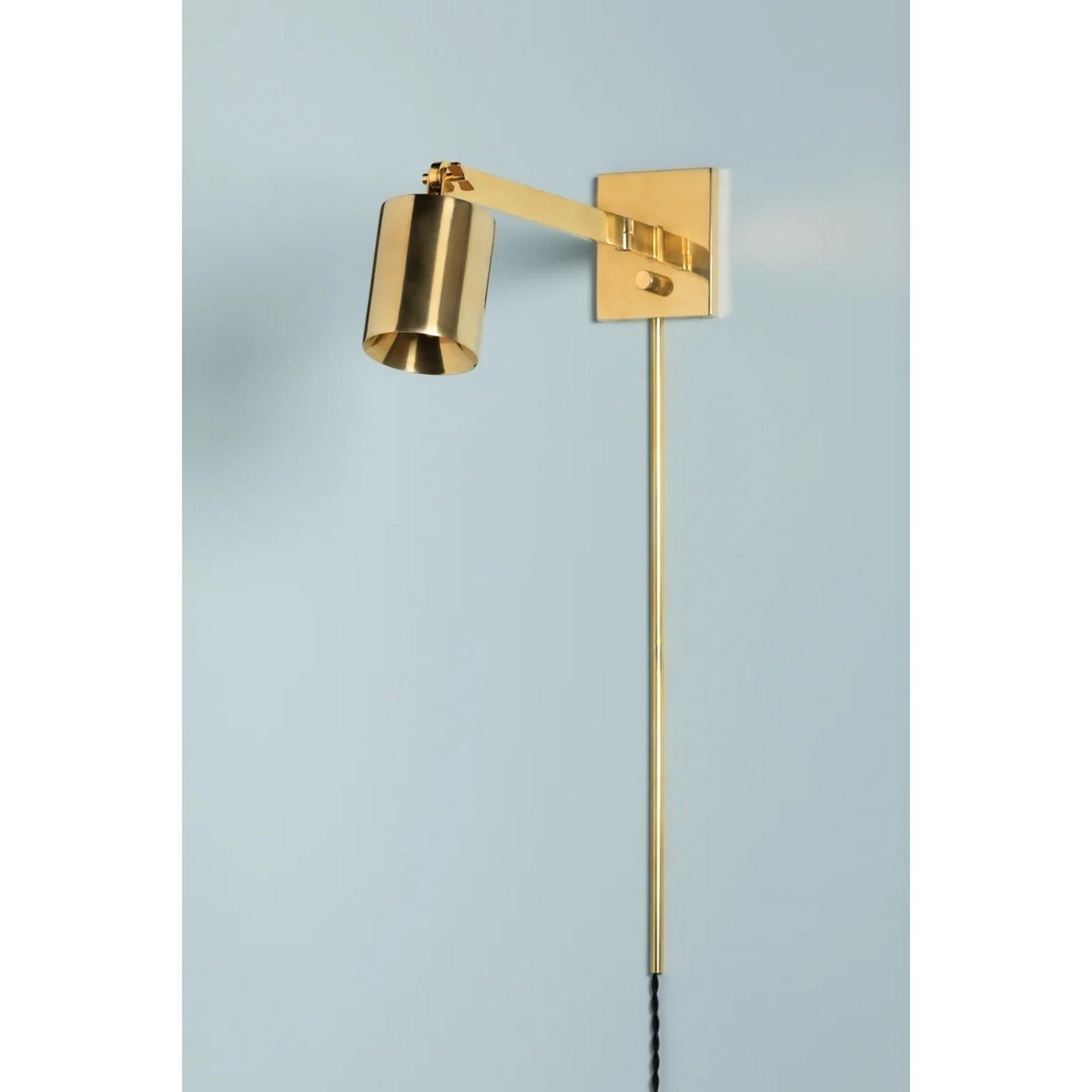 A Vivant Swing Arm Sconce with Aged Brass color