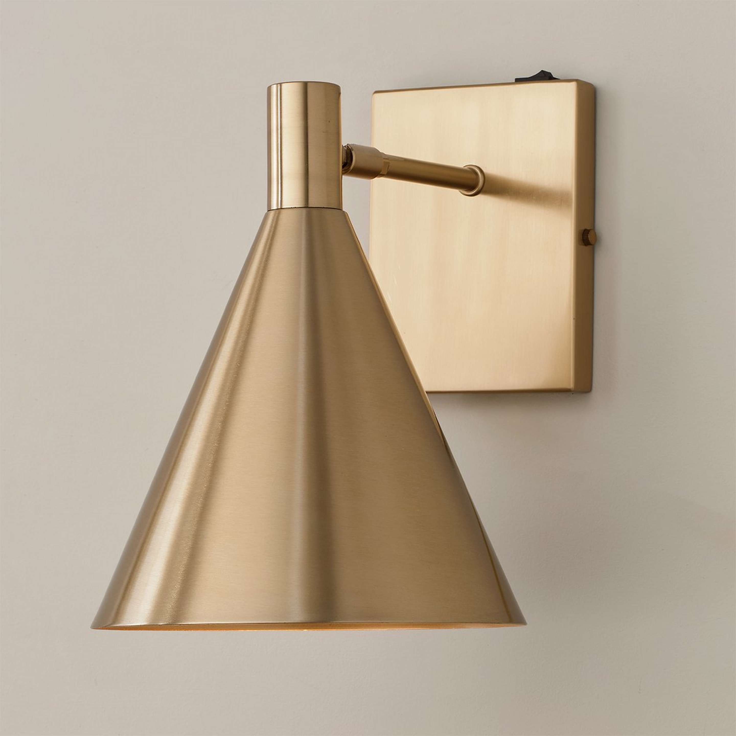 A Nubia Swing Arm Sconce with Aged Brass color