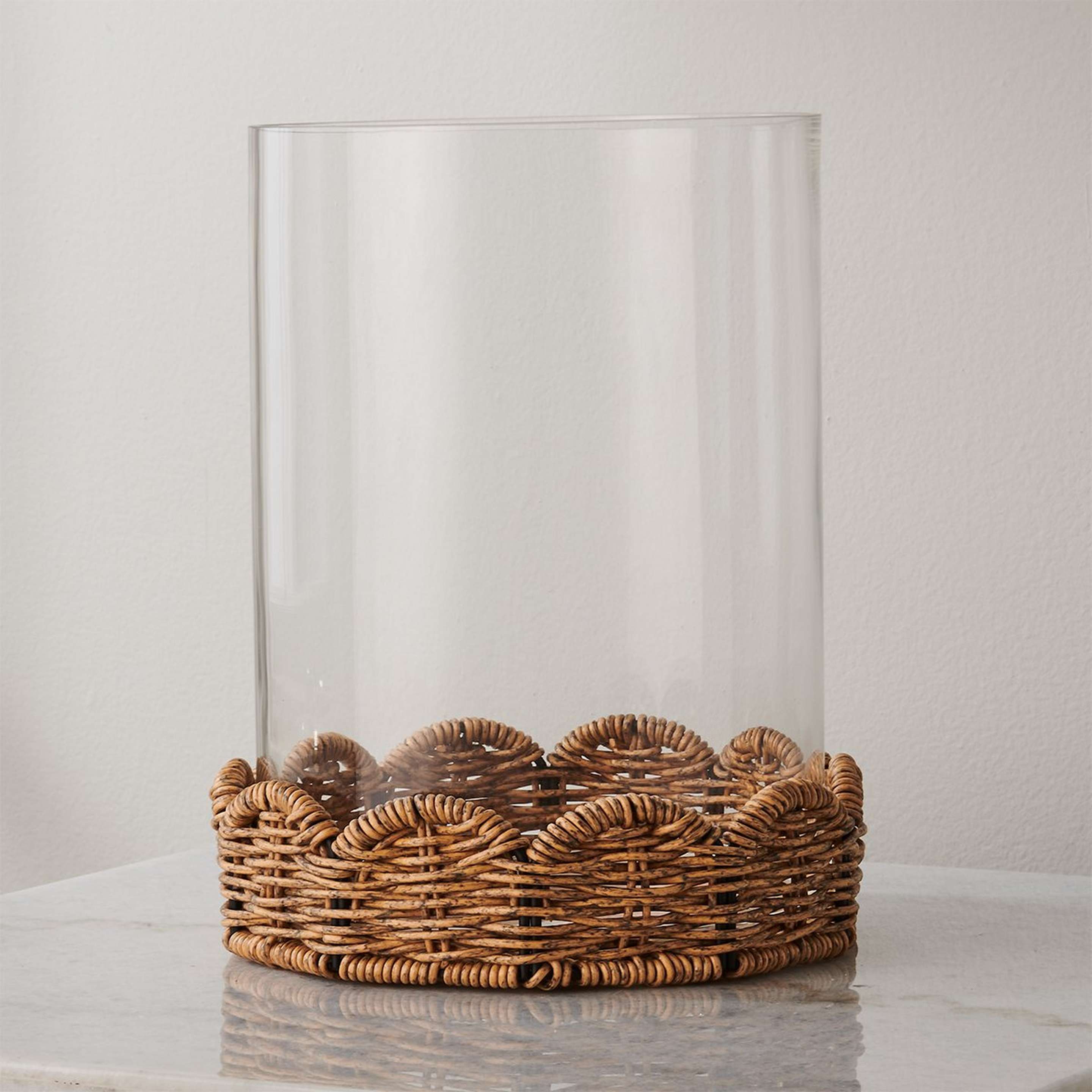 A Rota Candleholder with Clear Glass / Natural Rattan color