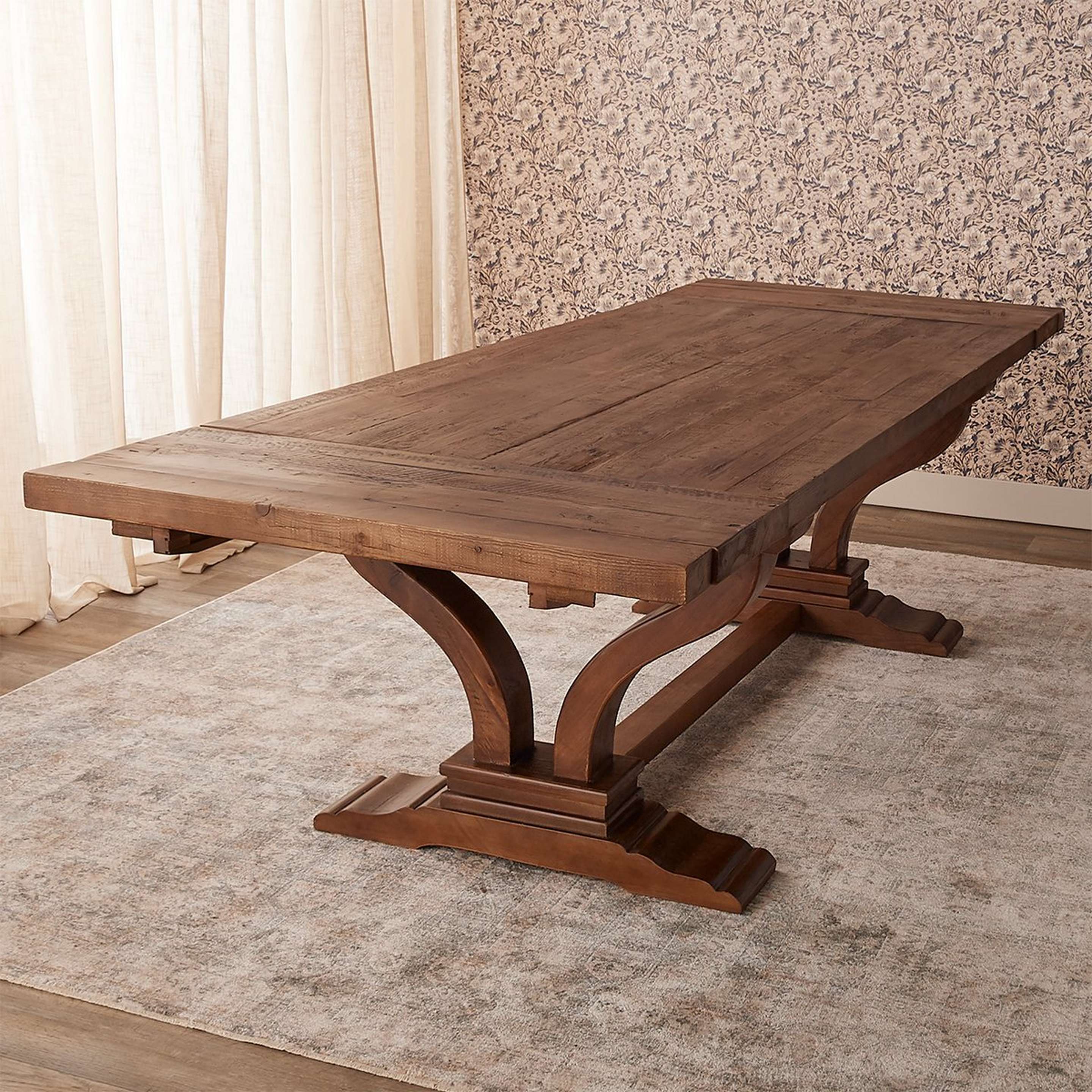 A Rohane Dining Table with Distressed / Warm Pine color