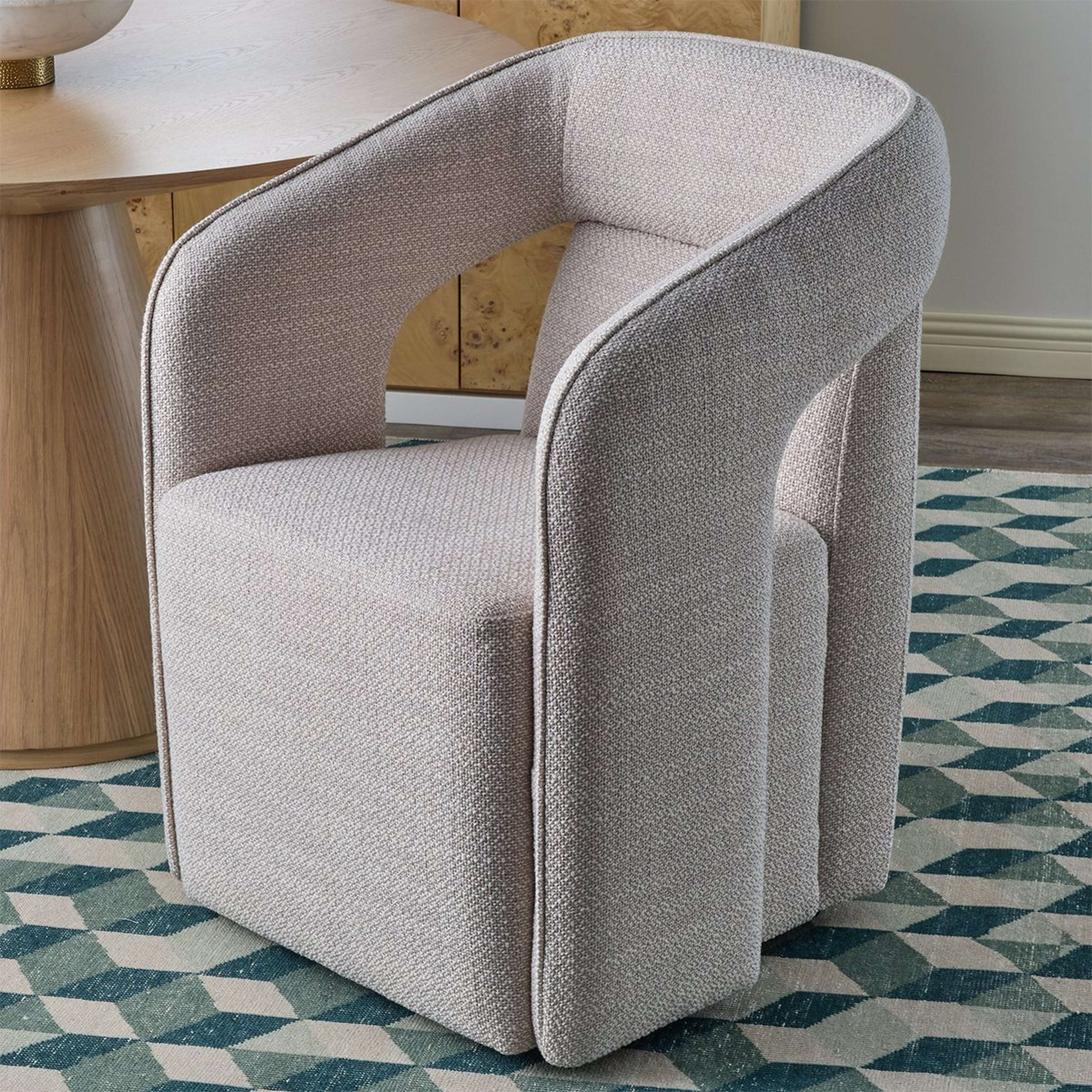 A Caballito Rolling Dining Chair with Soft White Upholstery color