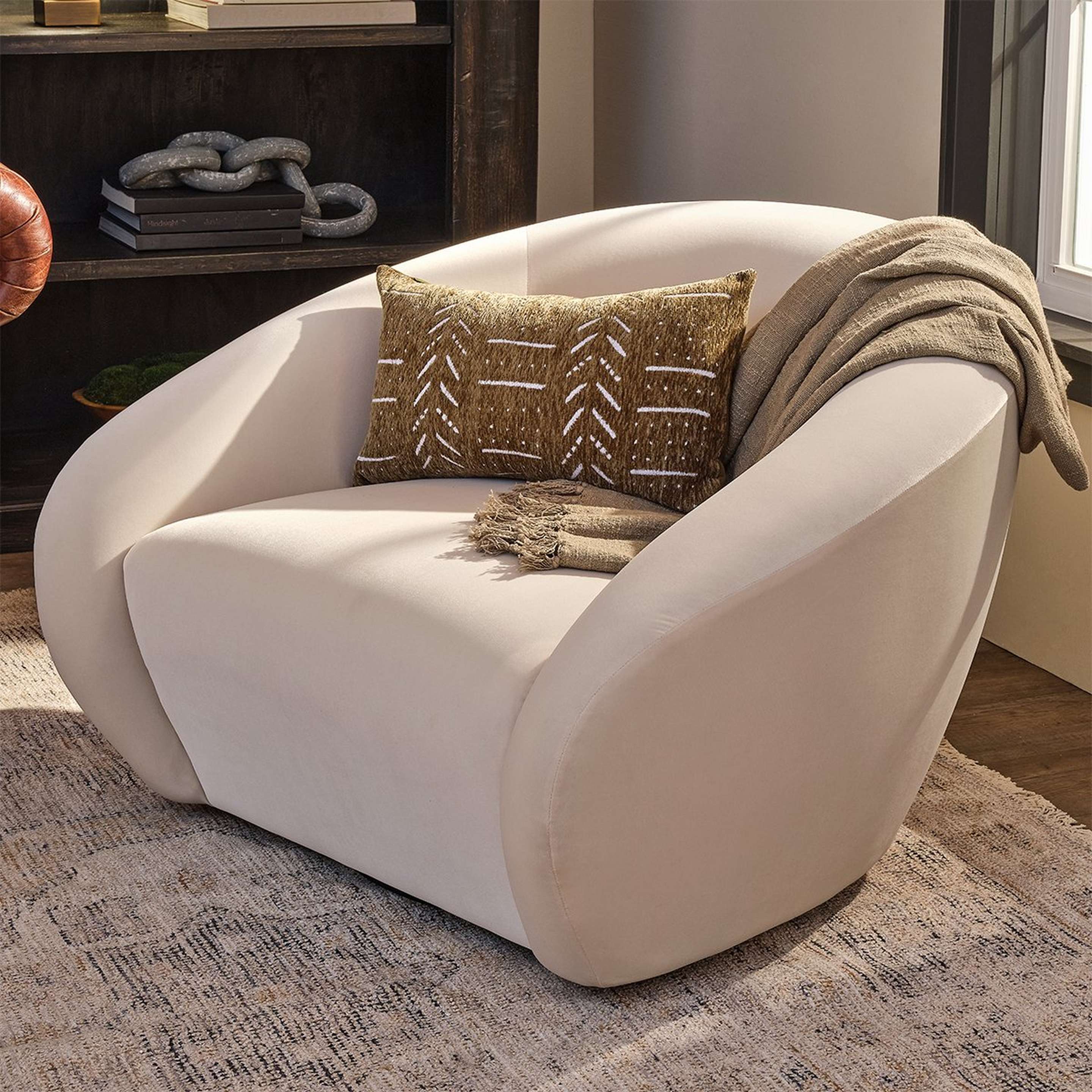 A Moreau Swivel Accent Chair with Cream Velvet color