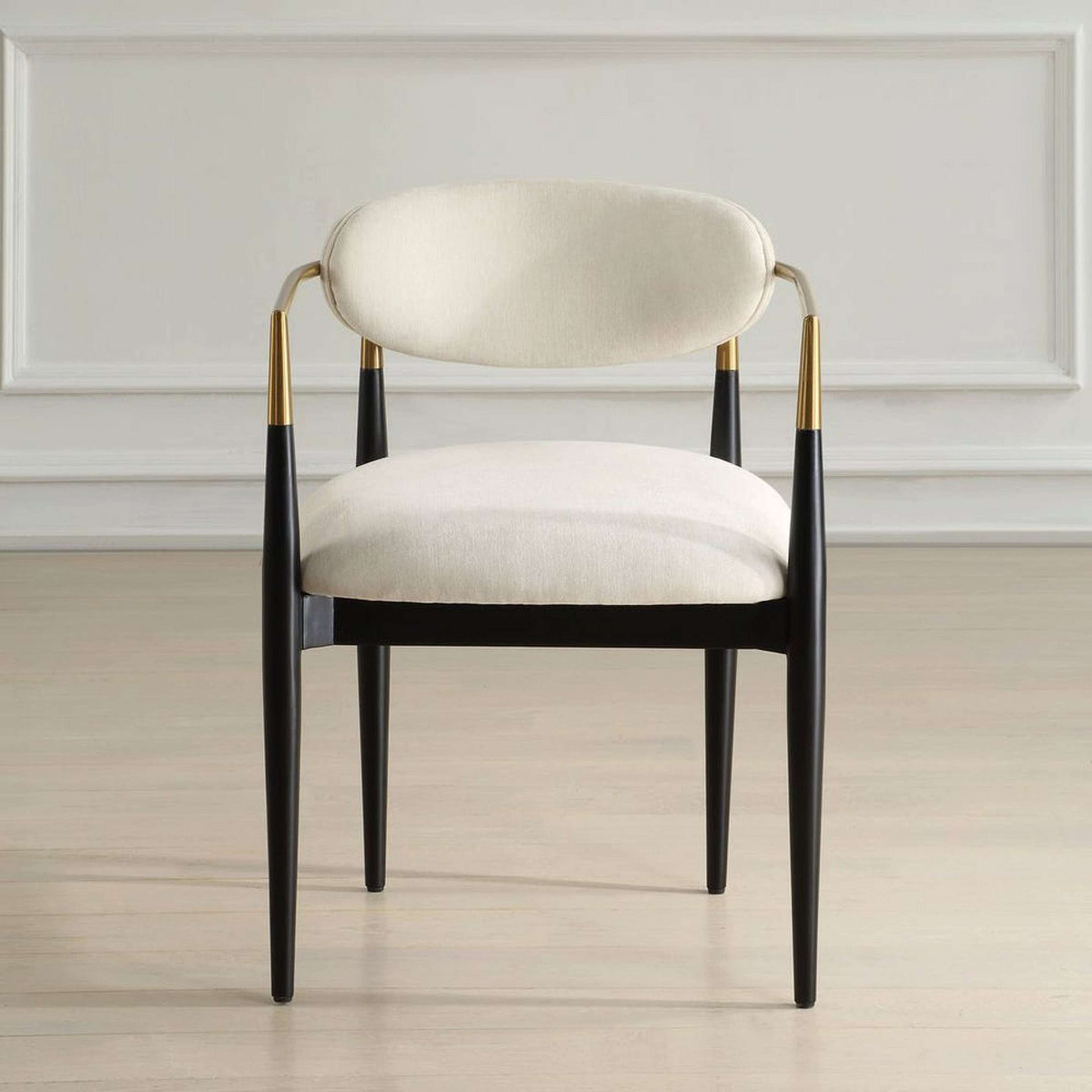 A Celia Dining Chair with Black / Cream Velvet Upholstery / Brass color