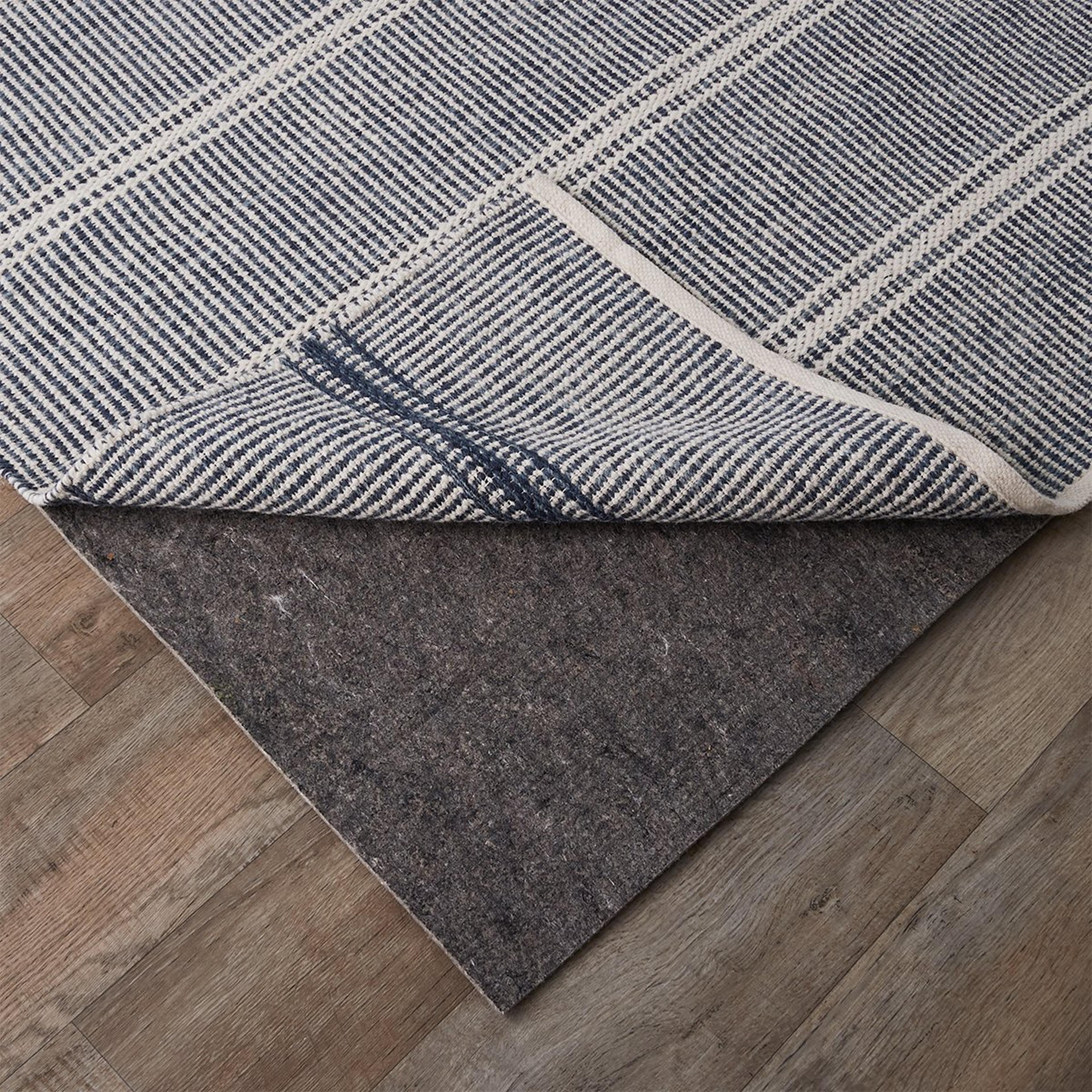 A Double Duty Carpet and Wood Floor Rug Pad with Gray color