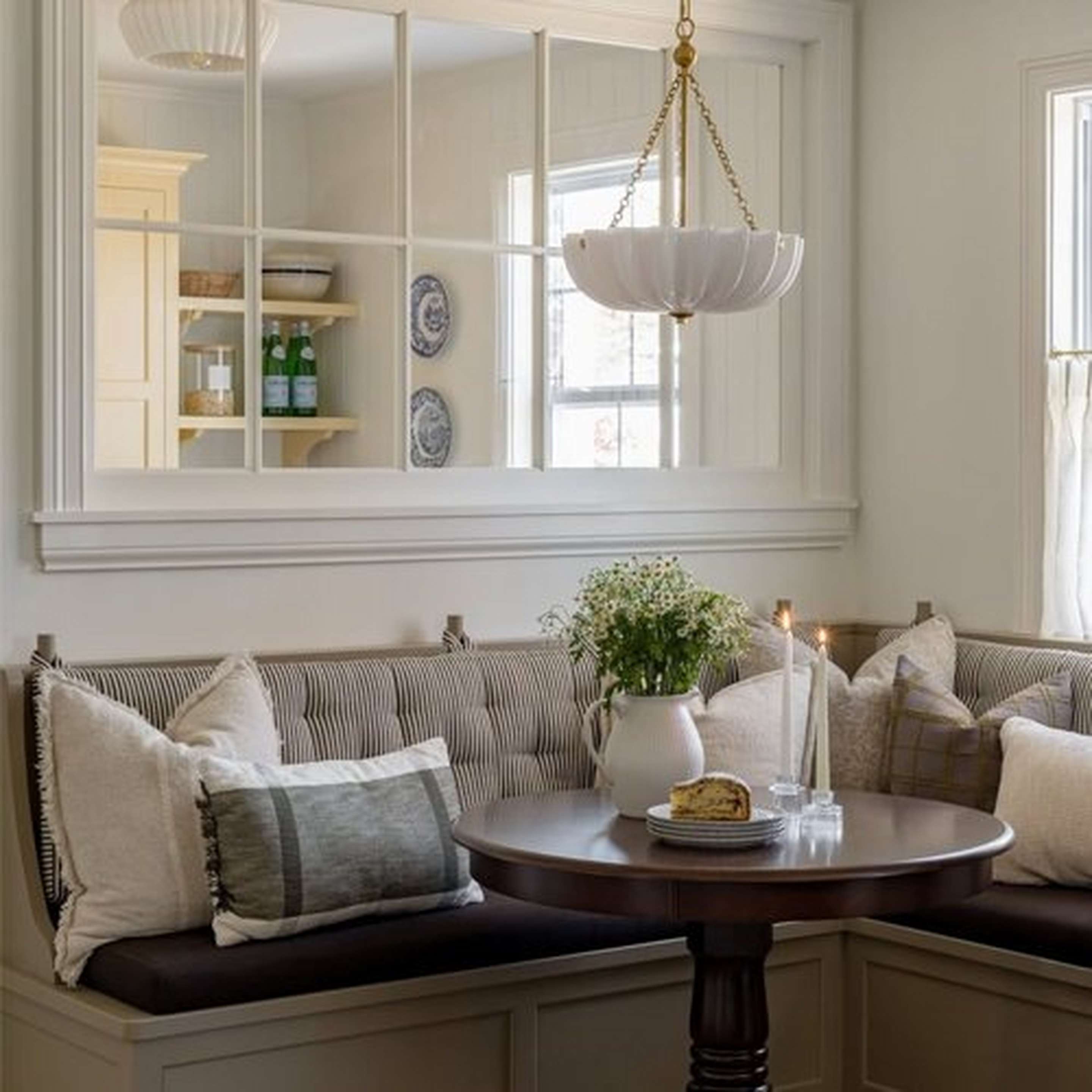 Aged Brass and Opal Glass Zenaida Chandelier in a dining nook