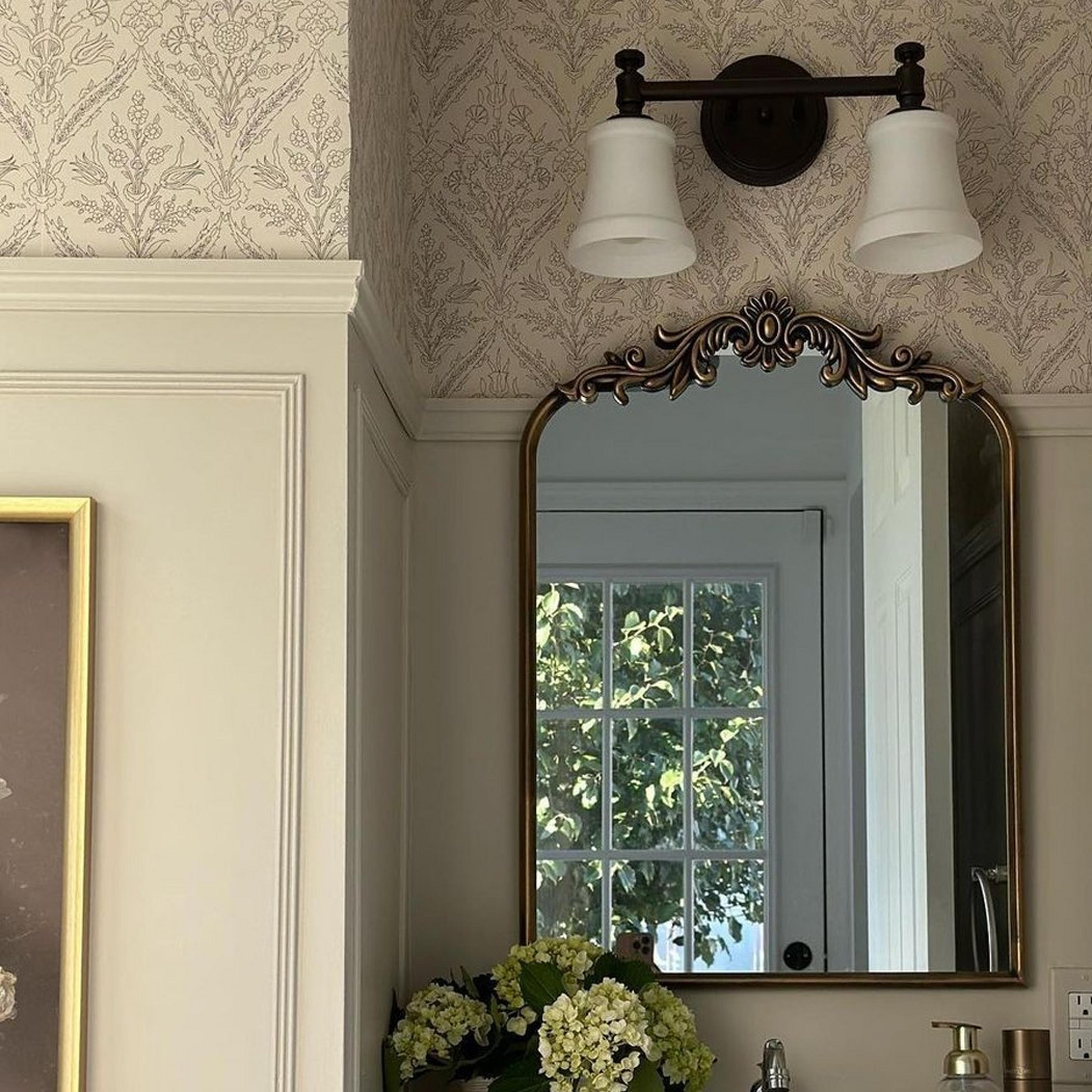 Mercer White Glass Vanity Light above ornate mirror