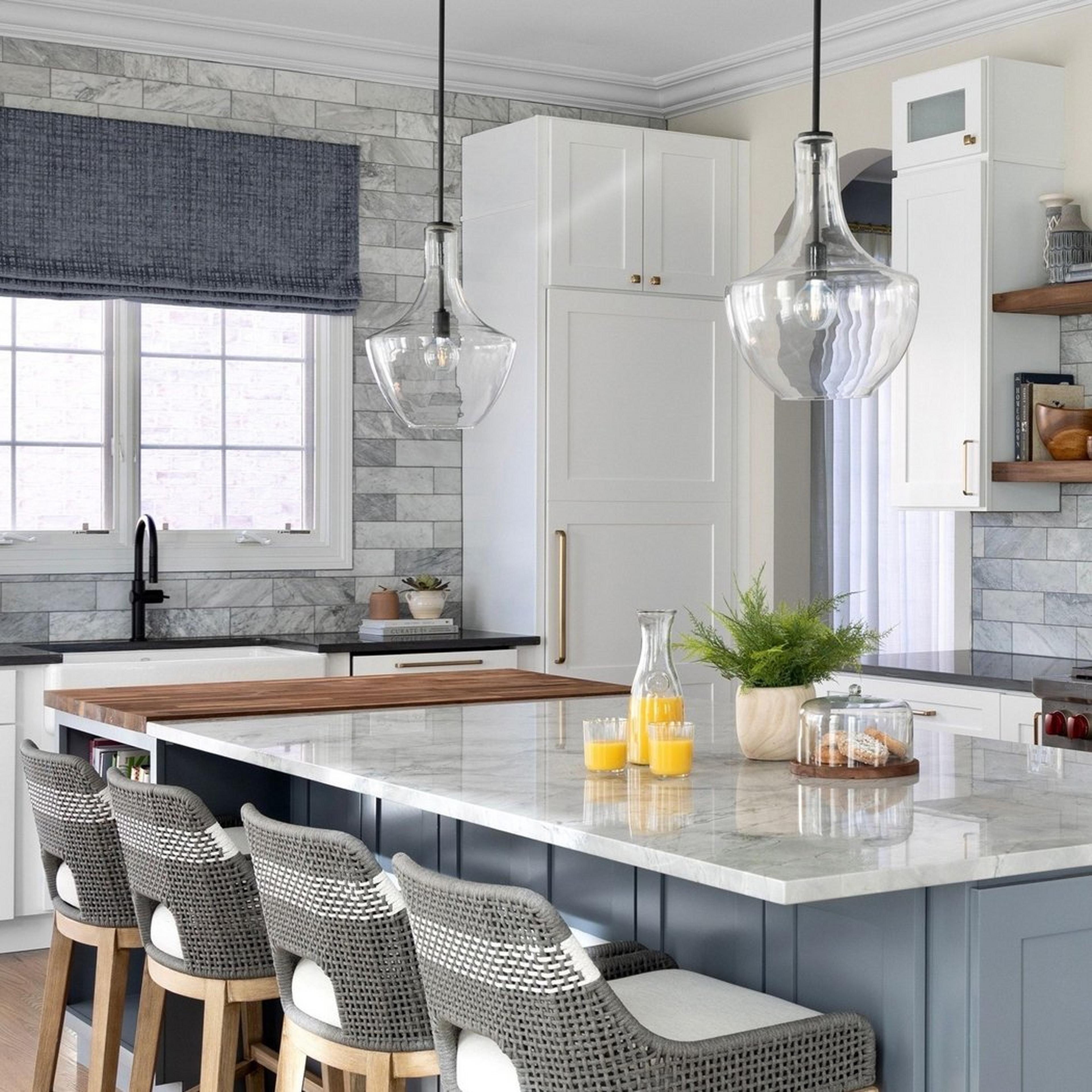 Large black drake glass pendants in a gray and blue kitchen