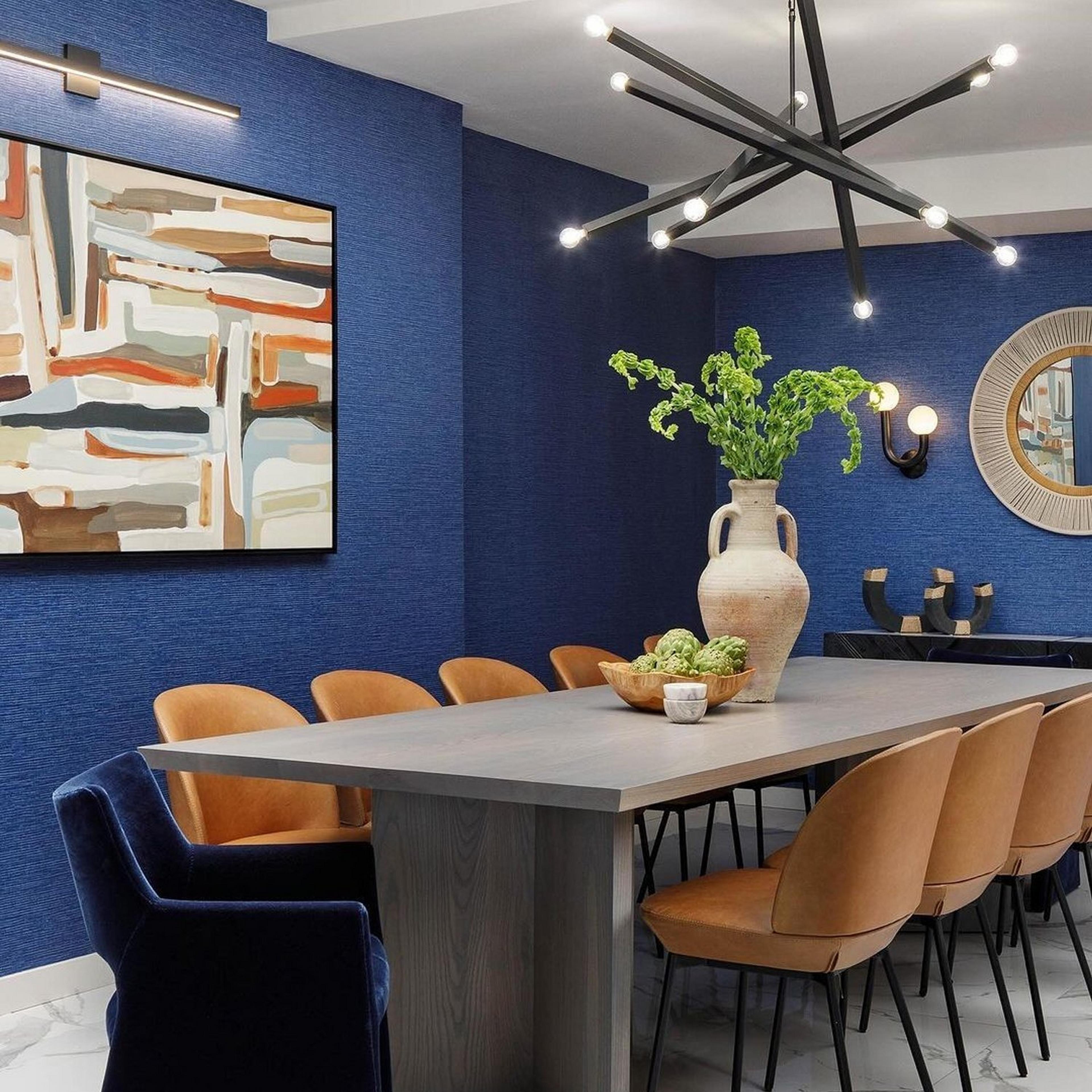 Bronze Barre Chandelier in a dining room with blue walla