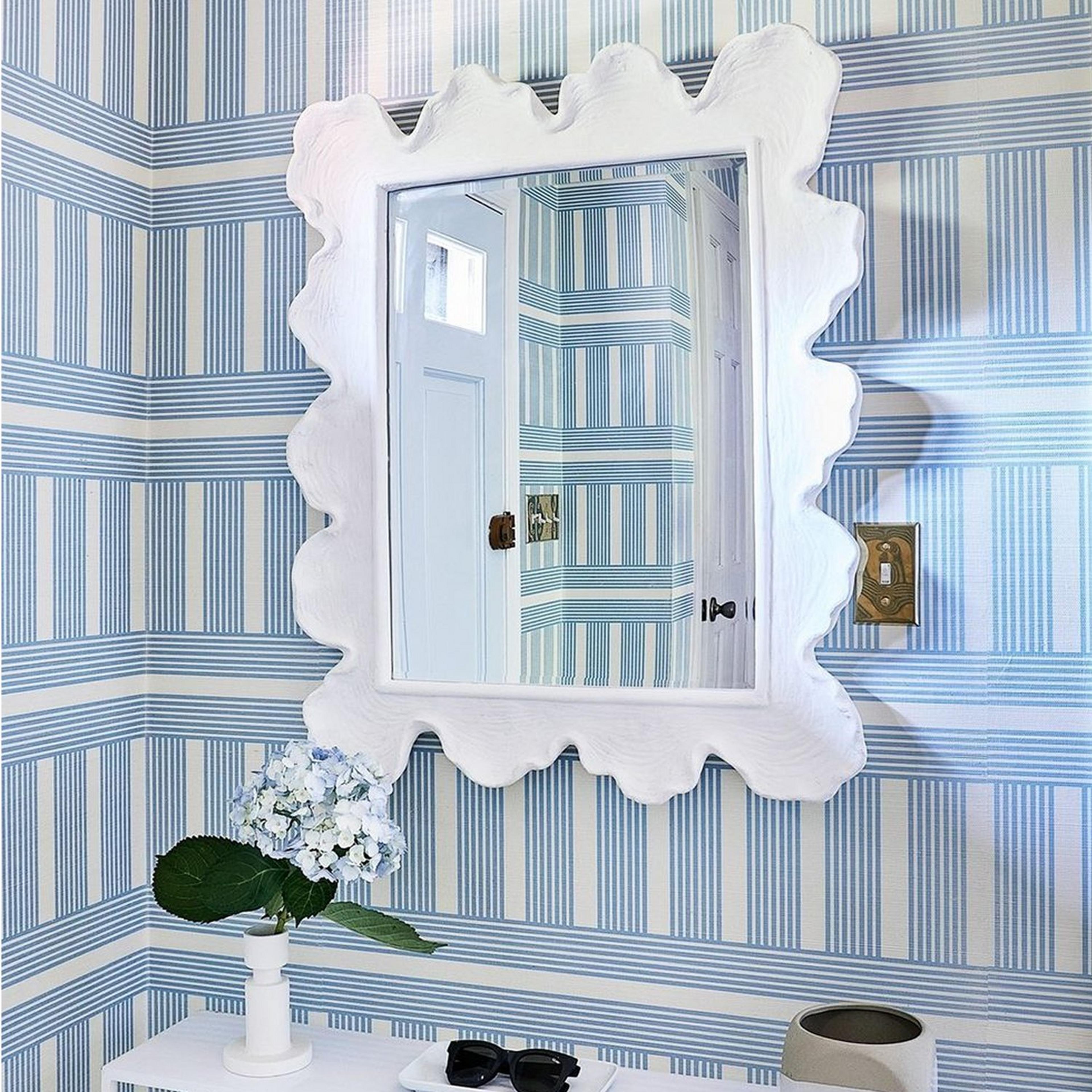 White Coral Curve Mirror on blue and white geometric wallpaper