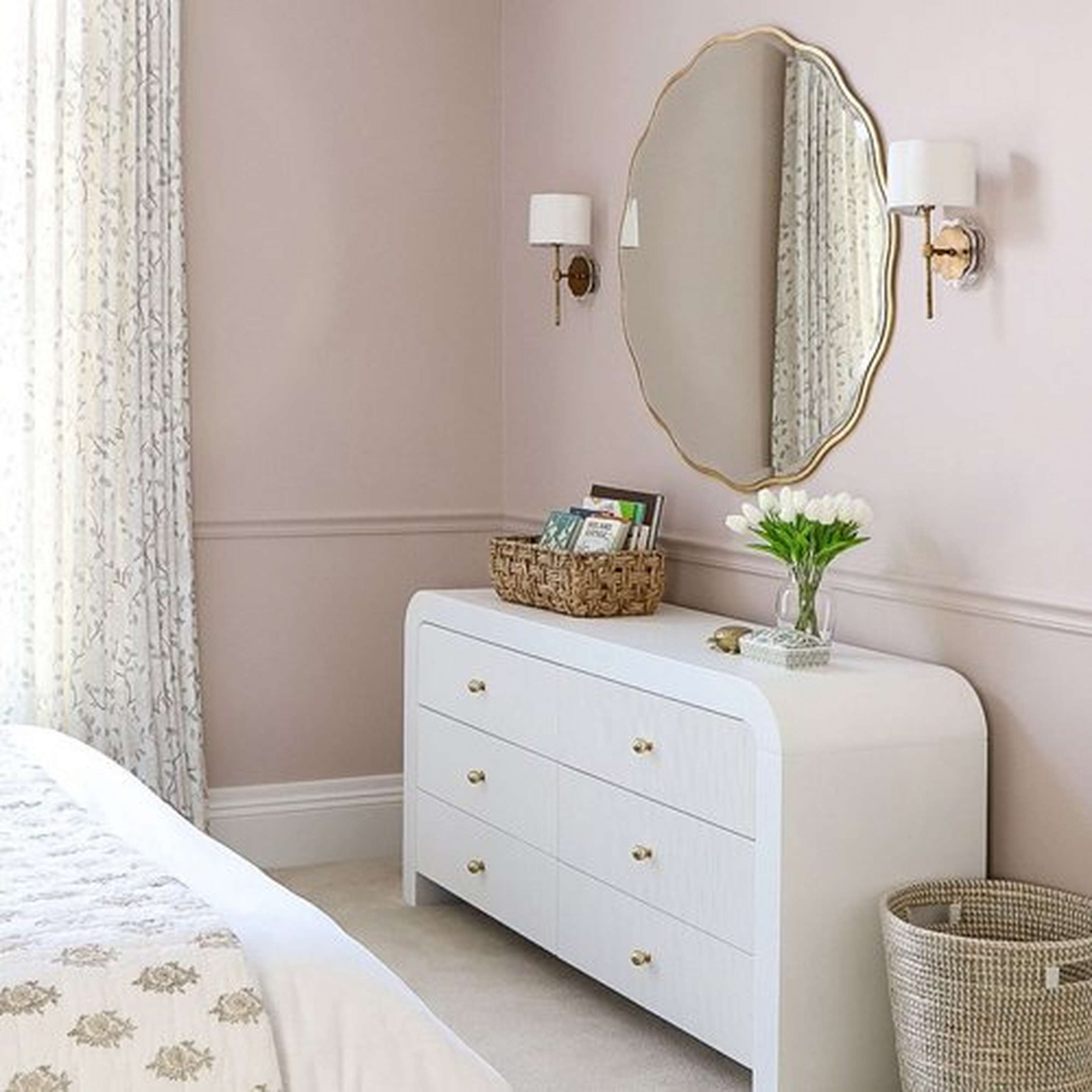 Two Scalloped Daisy Shade Sconces beside a gilded mirror