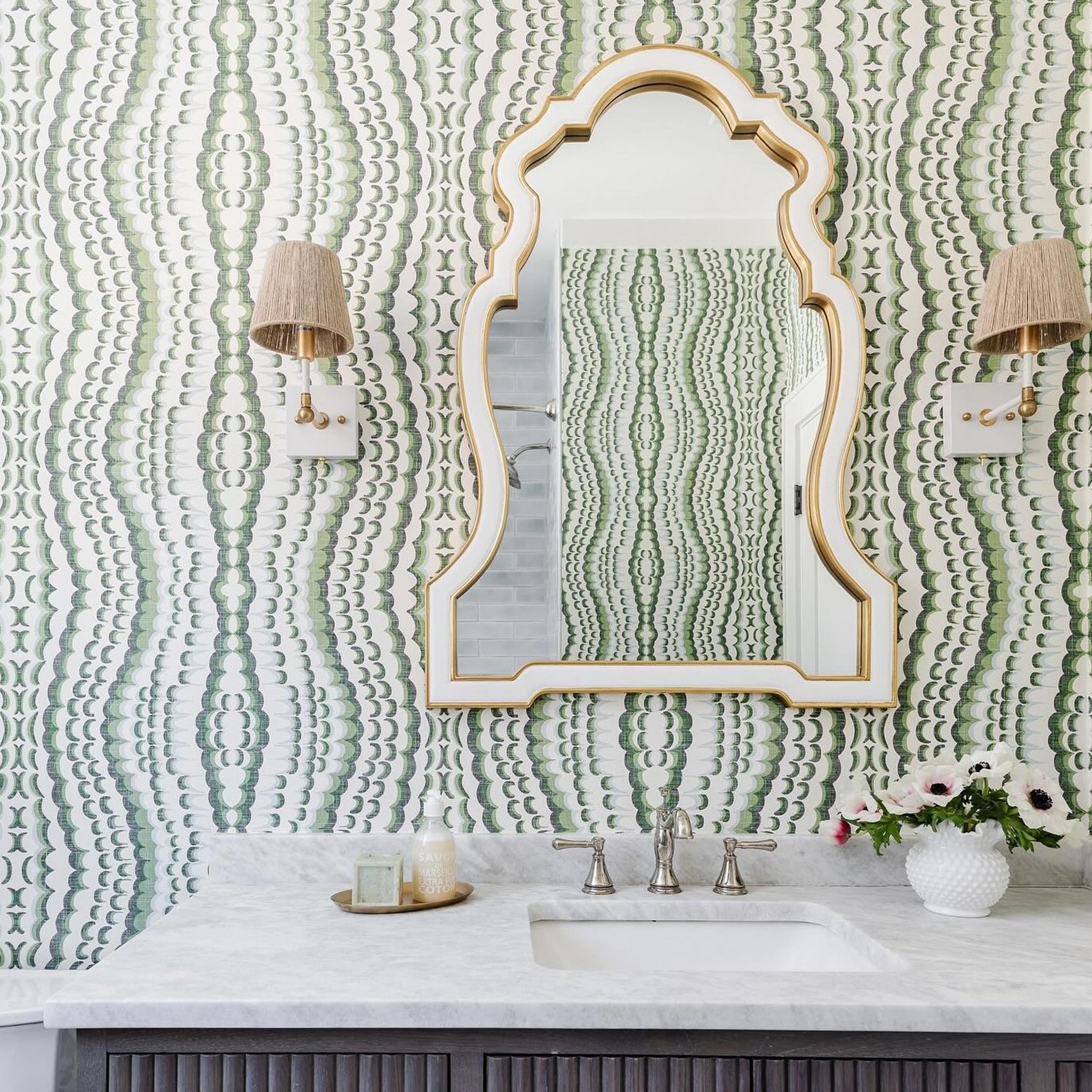 Two-Tone Intricate Arched Mirror in bathroom with abstract green wallpaper