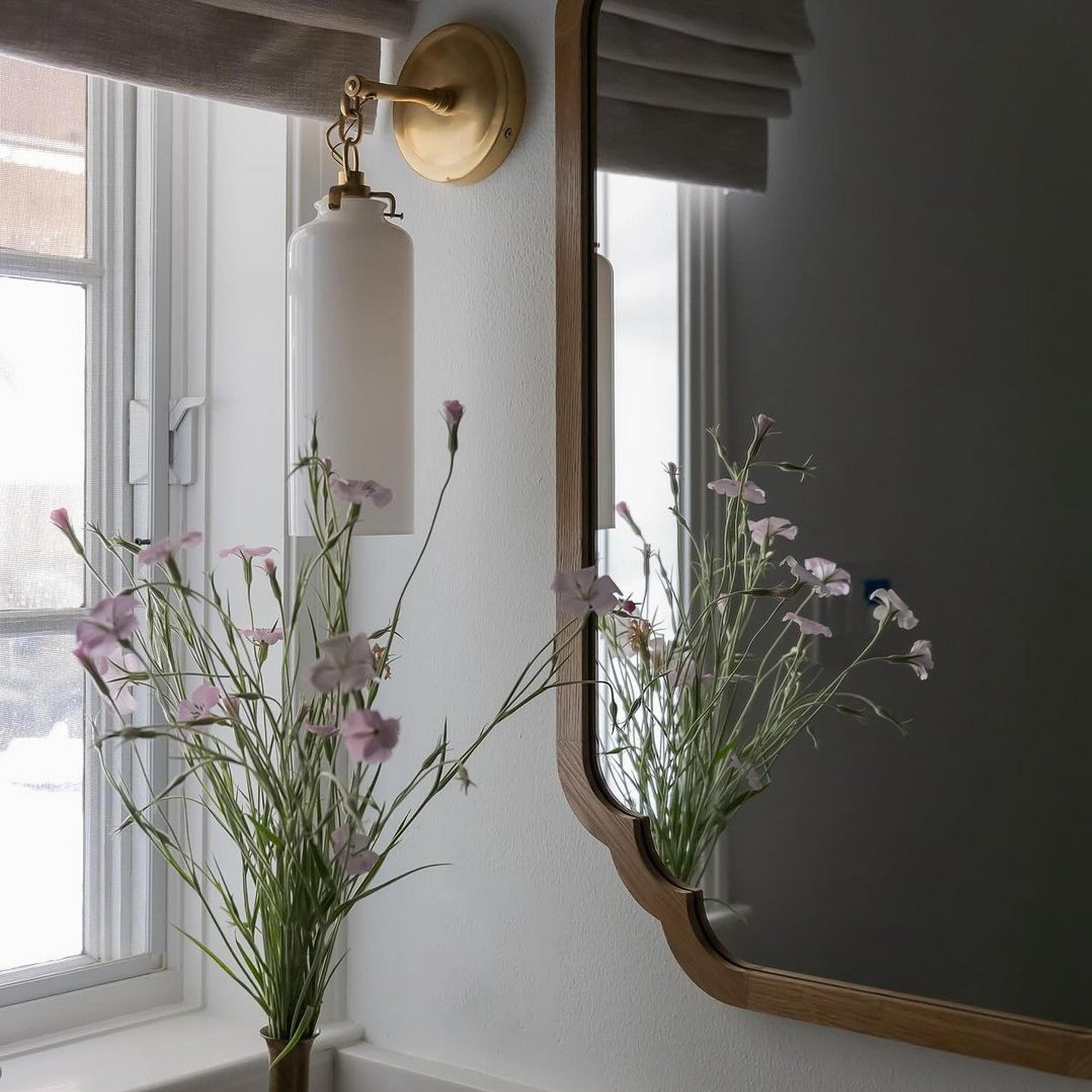 Gold Leaf Scalloped Edge Mirror in a dimly lit bathroom