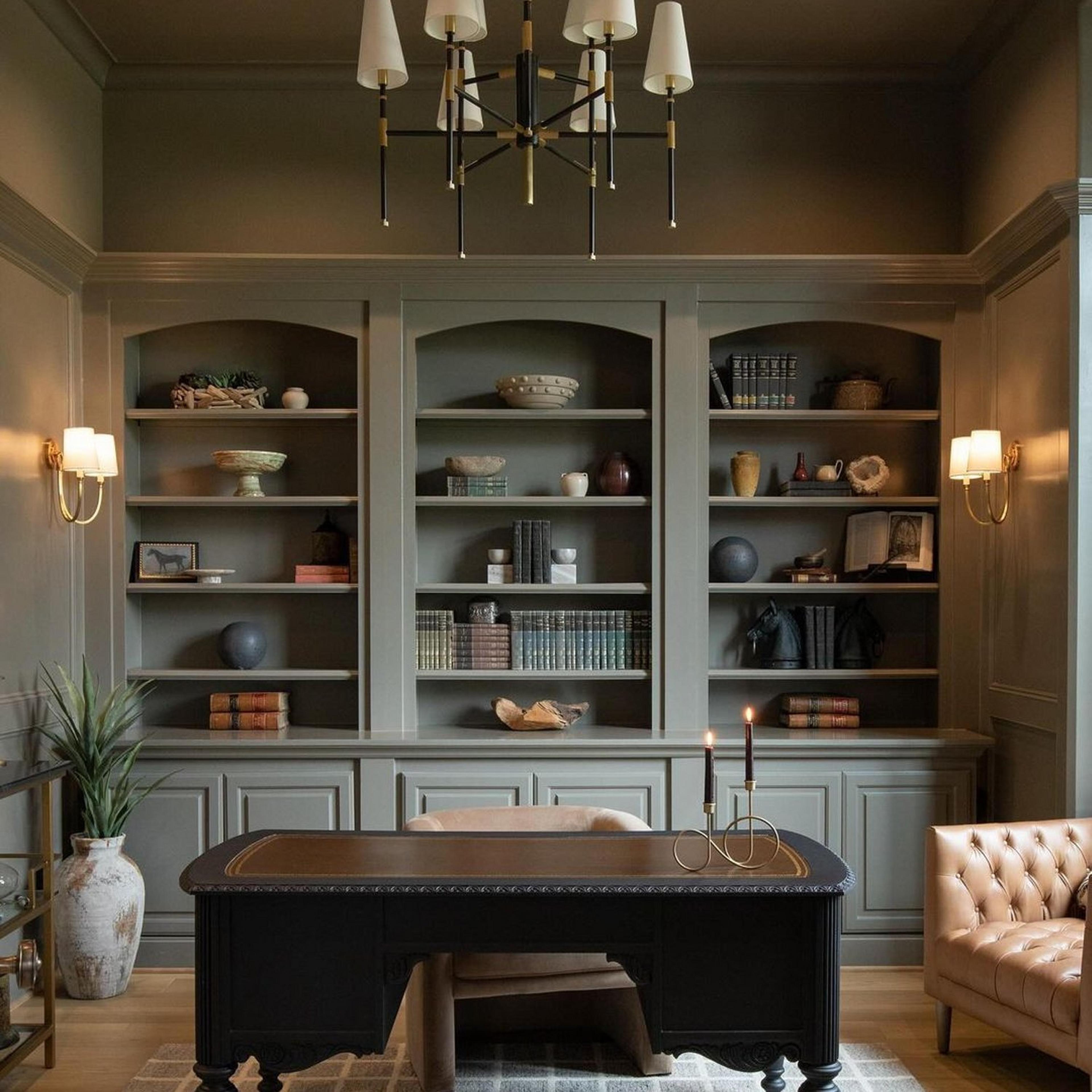 Antique brass Swag Sconces in an impressive home office with tall bookshelves