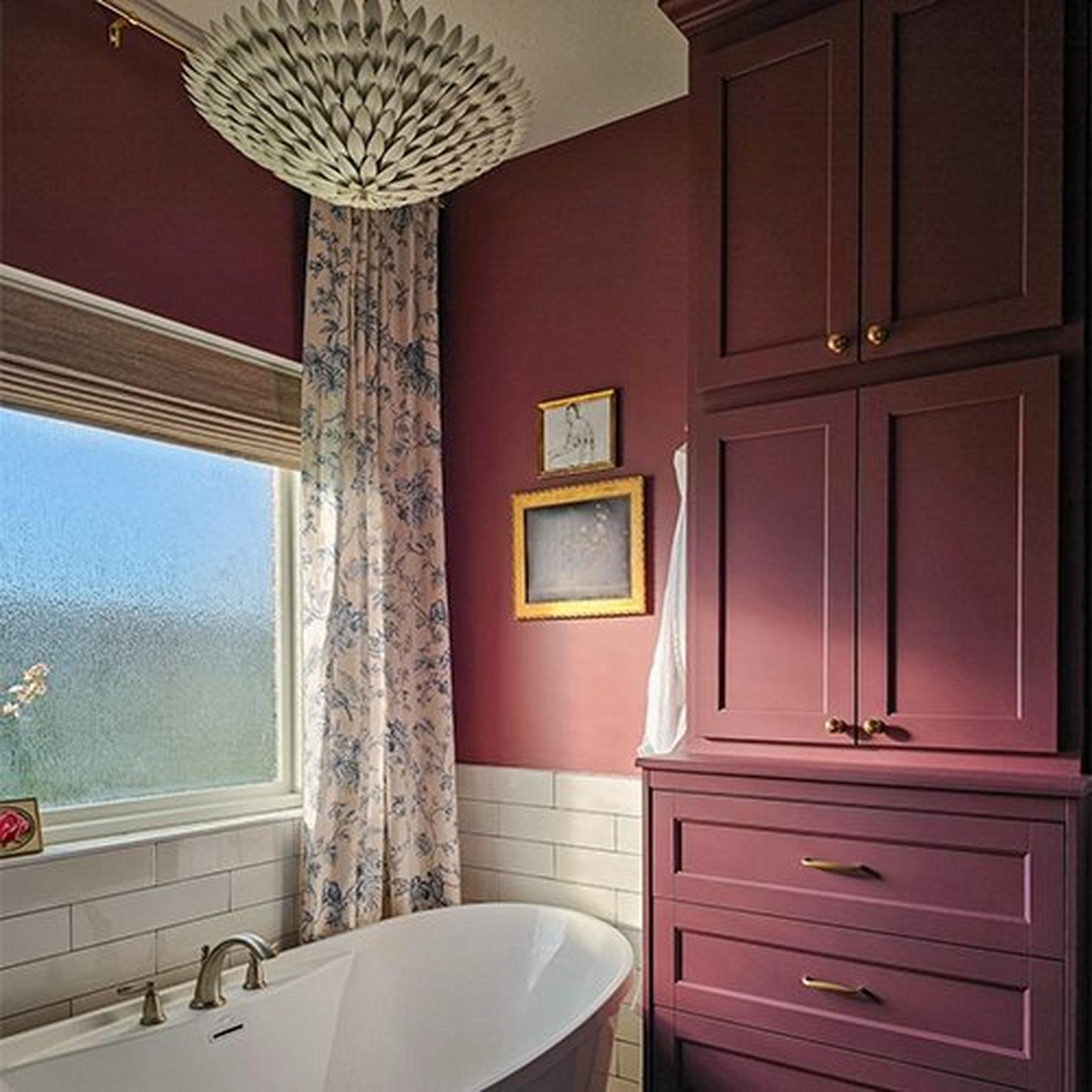 Matte white olive leaf chandelier in bathroom with burgundy walls
