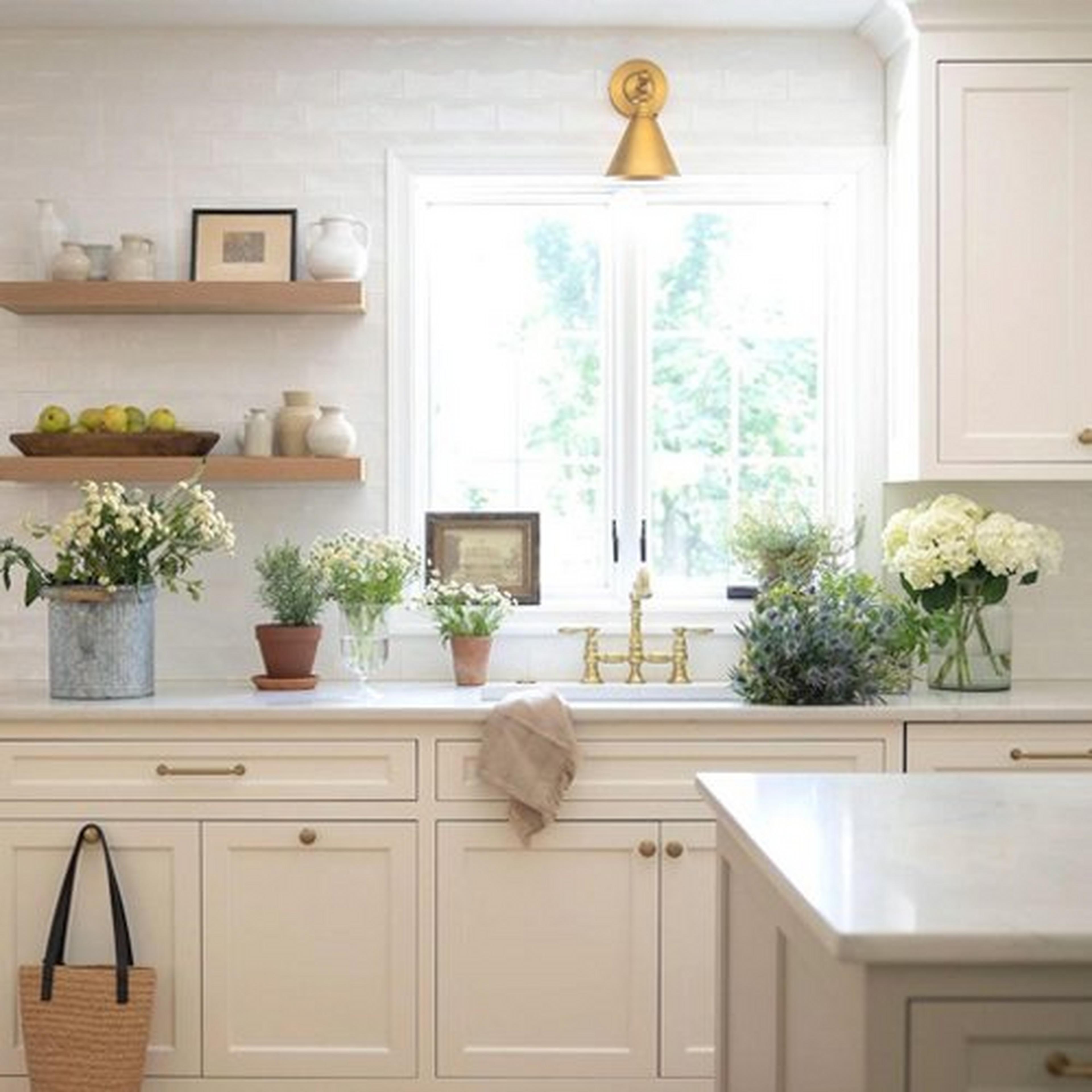 Aged Brass  Adjustable Study Swing Arm Sconce hangs above a kitchen sink
