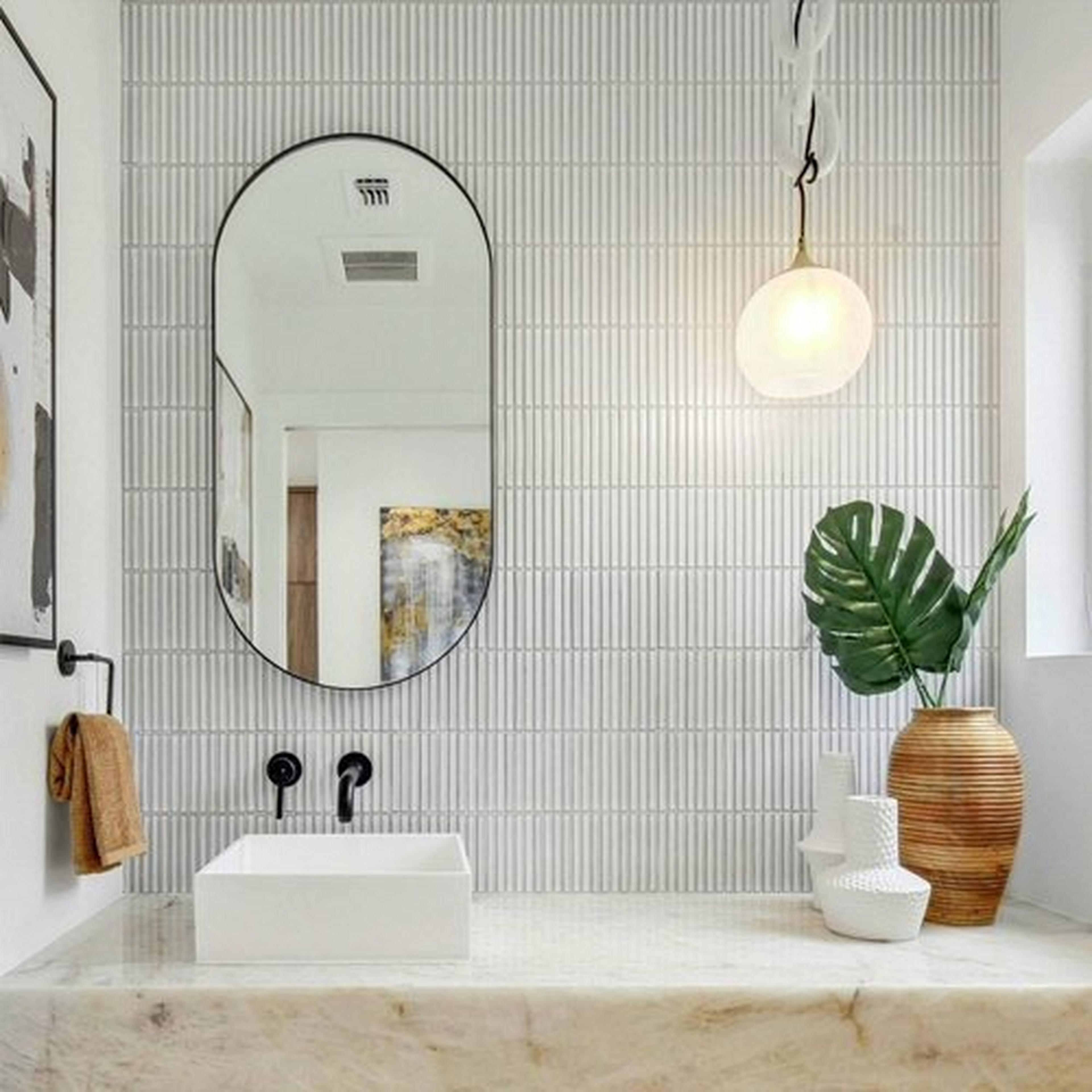 Brass and White Marble Stone Link Pendant hangs beside an Oval Mirror