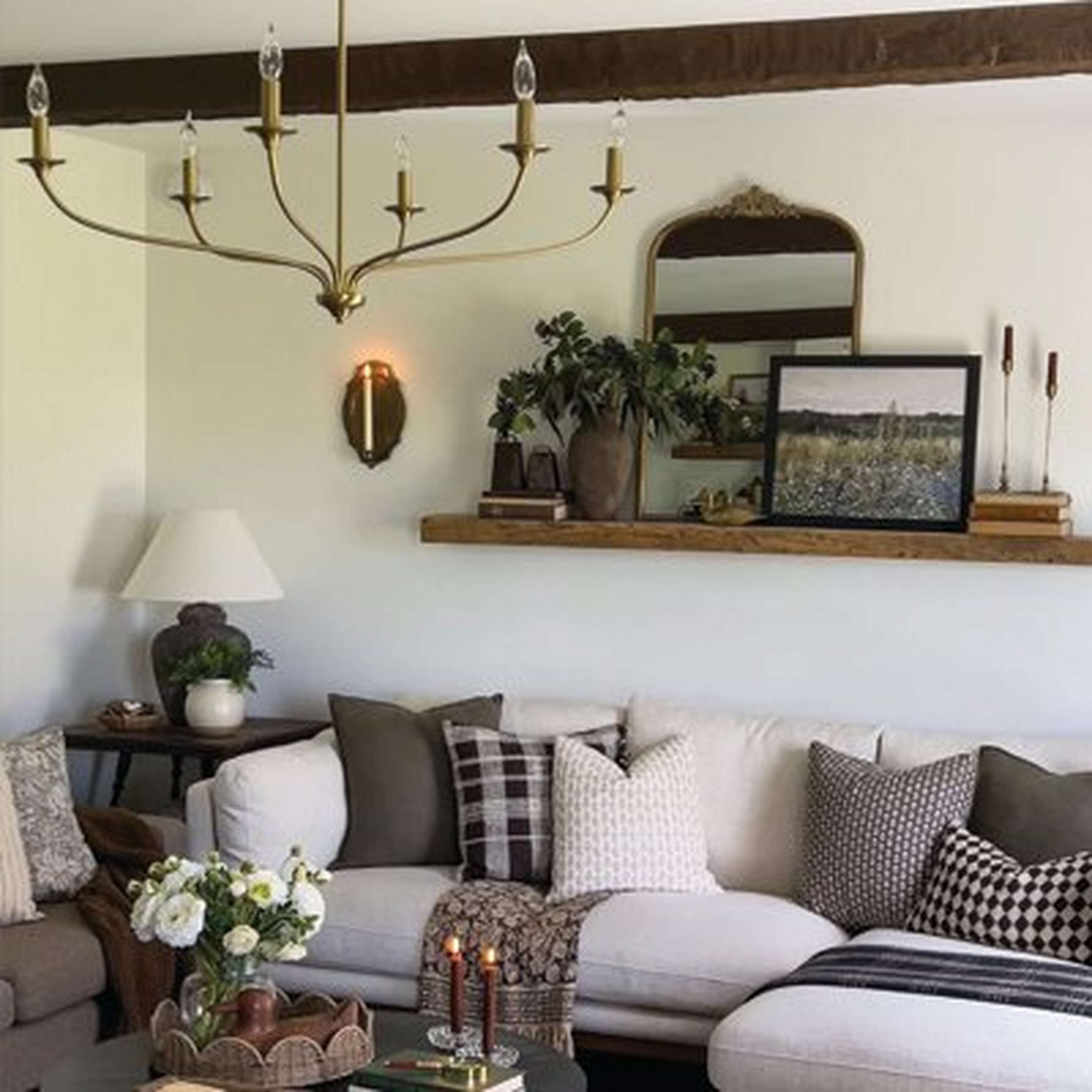 Cozy living room with a Matte Brass Alainey Chandelier