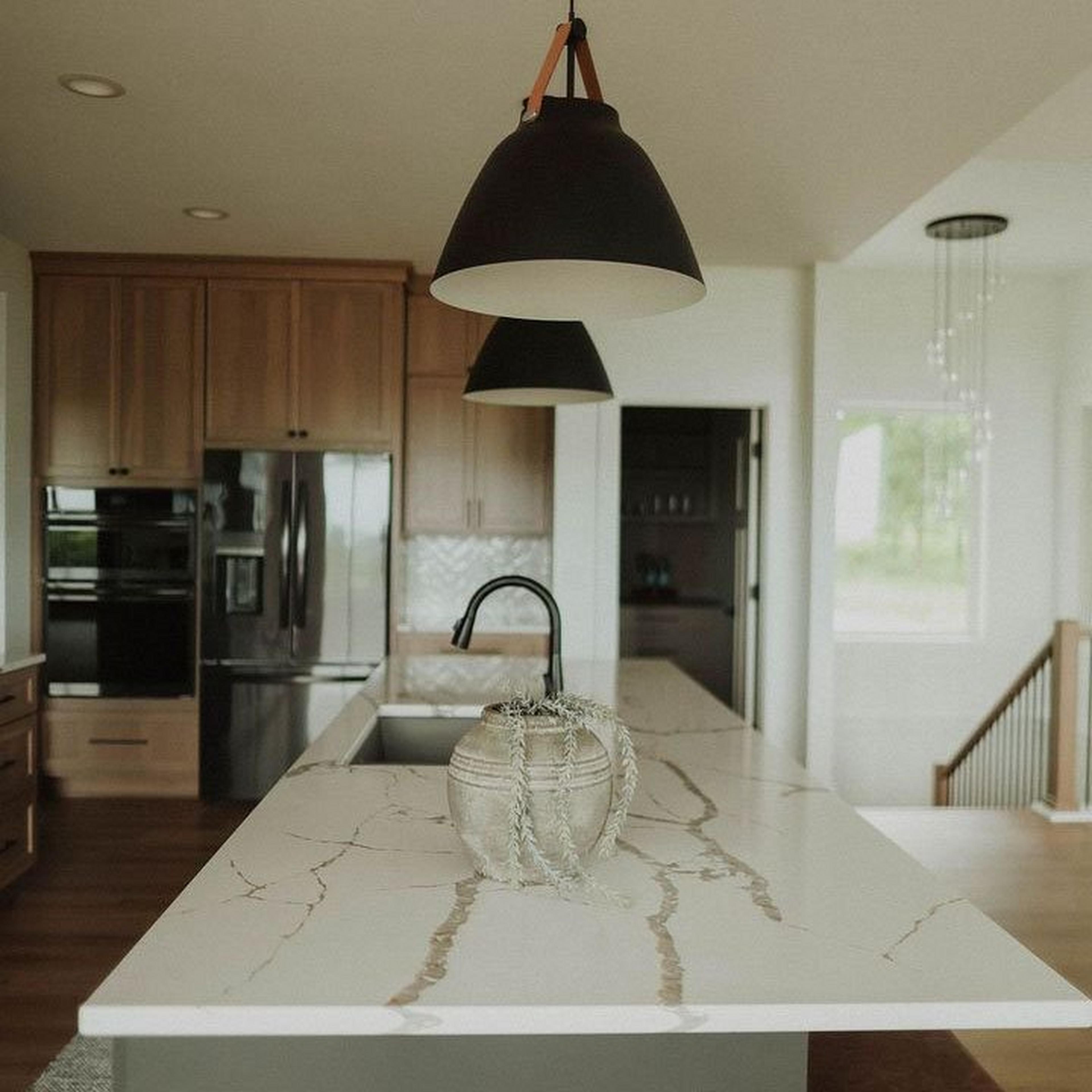 Carillon Pendats in a leather inspired kitchen with dark cabinets
