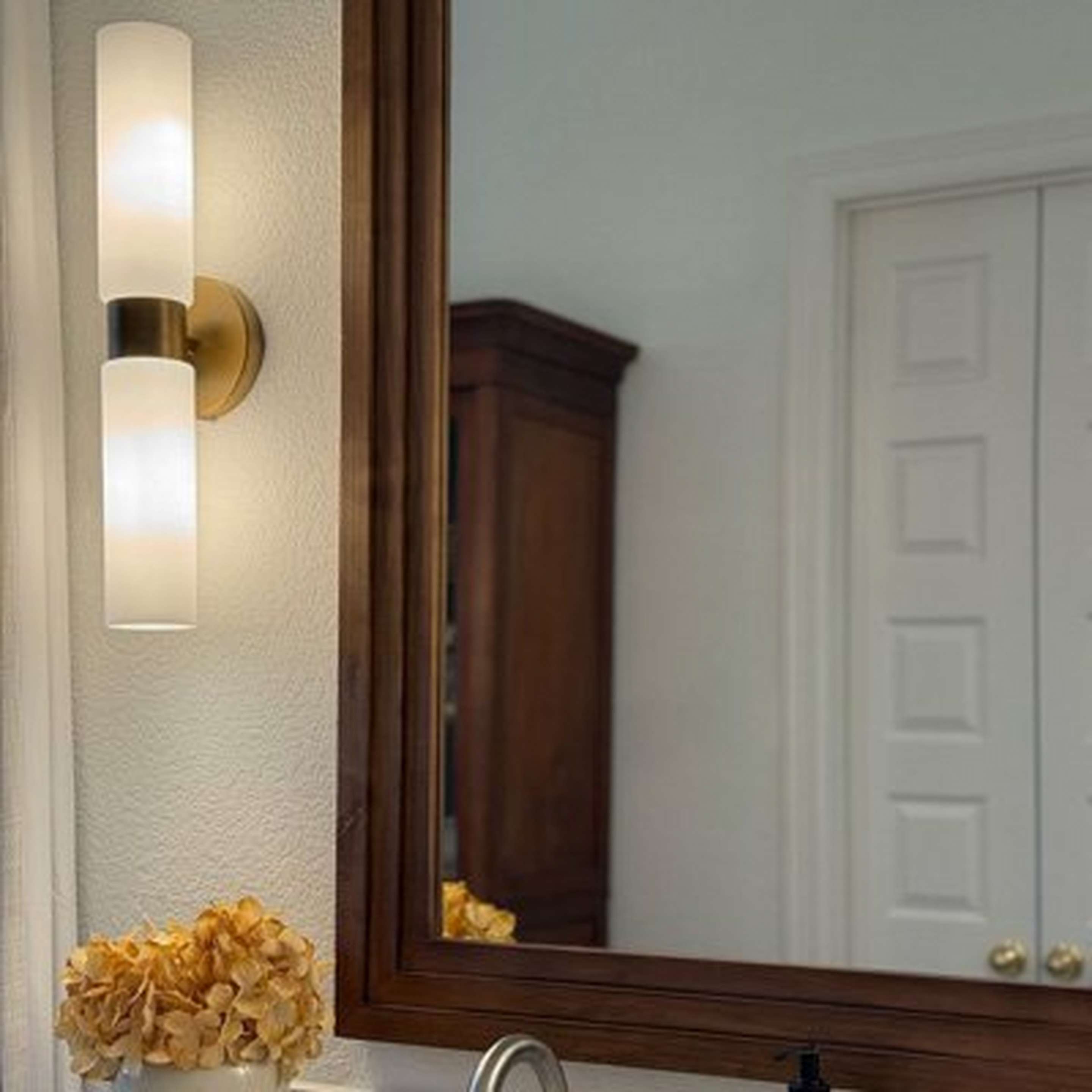Marsden Bath Sconces beside a wood framed mirror