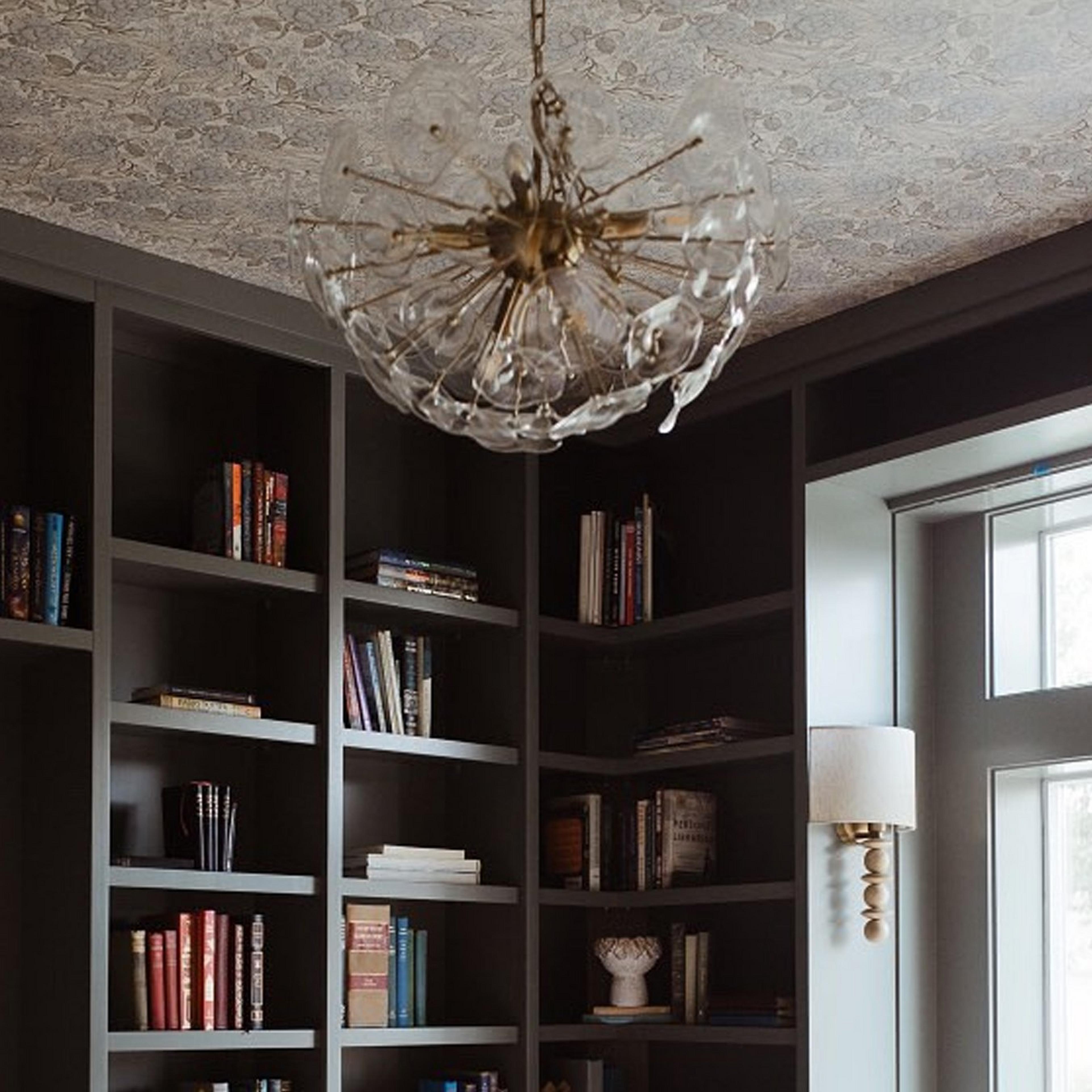 Aged brass and clear glass  in a home office with built-in bookshelves