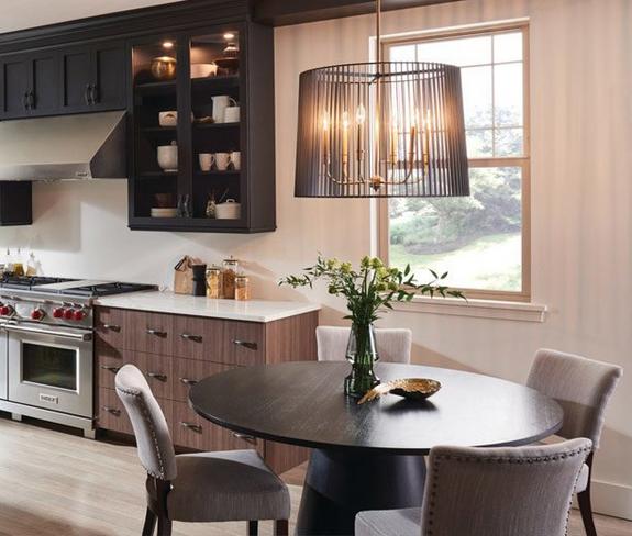 Black modern chandelier over round kitchen table