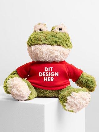Grøn frø med rødt T-shirt og påskriften "Dit design her".
