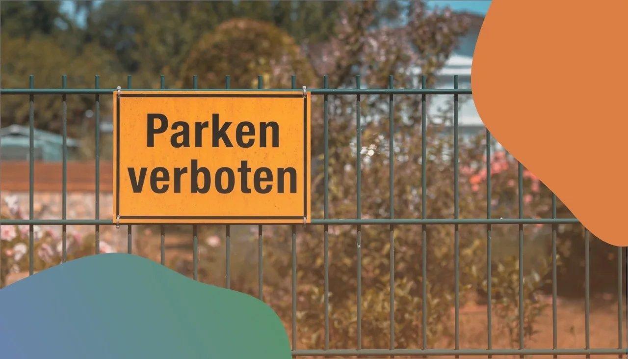 Zaun mit Schild, auf dem Parken verboten steht.