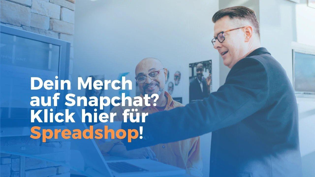 Mann zeigt und erklärt einem anderen Mann etwas auf einem Laptopbildschirm.