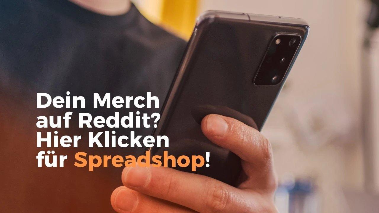 Hand hält ein Smartphone. Textoverlay: Dein Merch auf Reddit? Hier Klicken für Spreadshop!