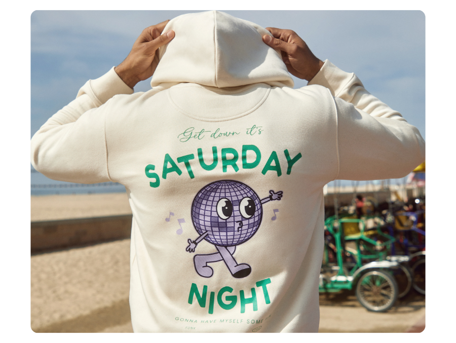 person wearing a hoodie with disco themed back design to show customization