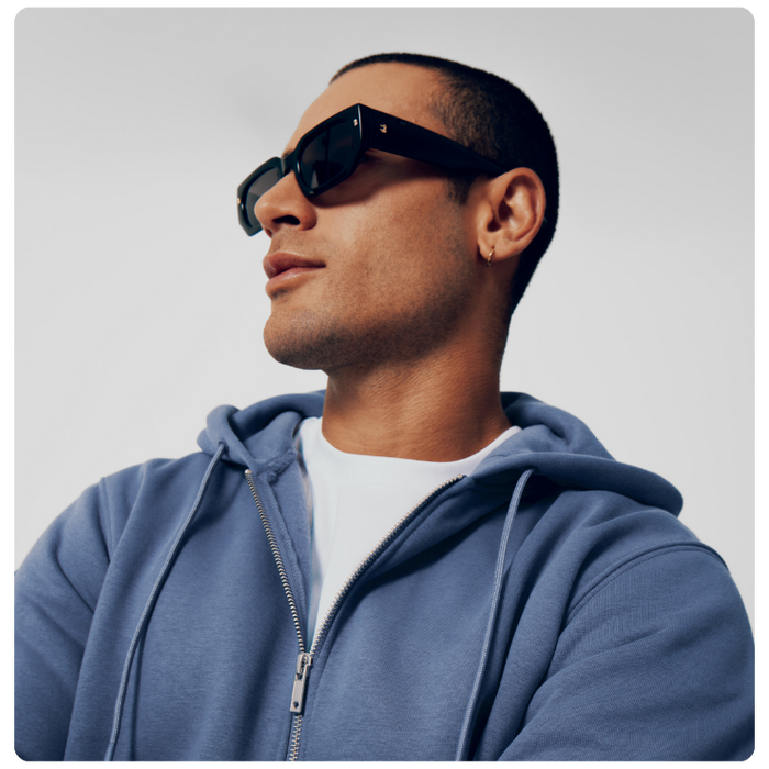 man wearing blue zip up premium hoodie to show benefit of premium products