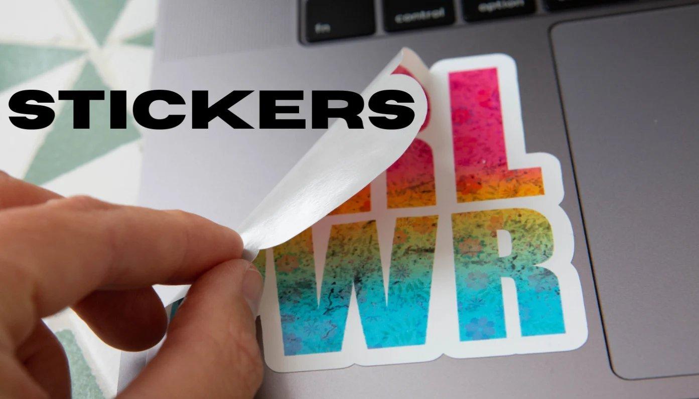 creator putting a sticker on a laptop