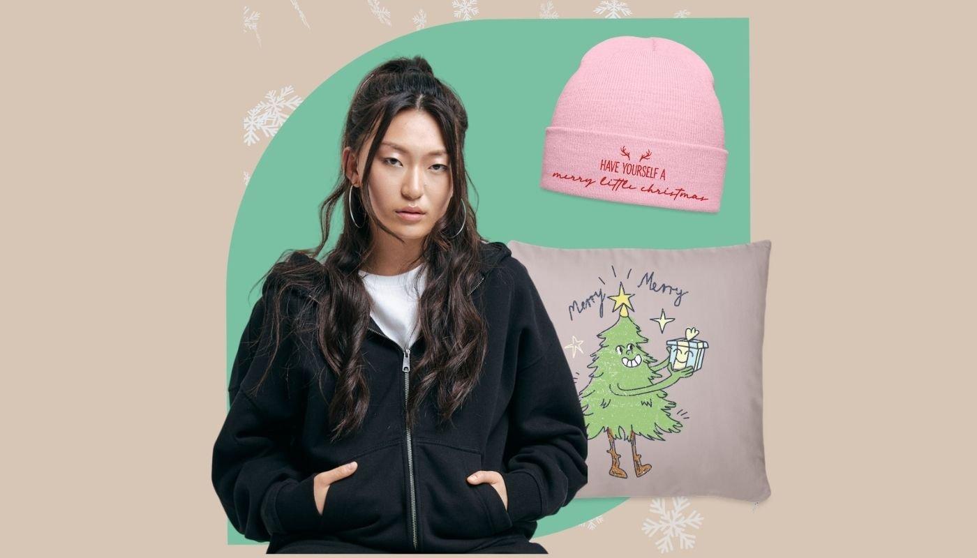 Cozy holiday bundle with model in black hoodie, pink beanie, and Christmas tree pillow.