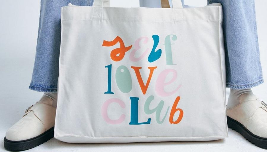 custom printed tote bag with self love club design to illustrate how to design print on demand products