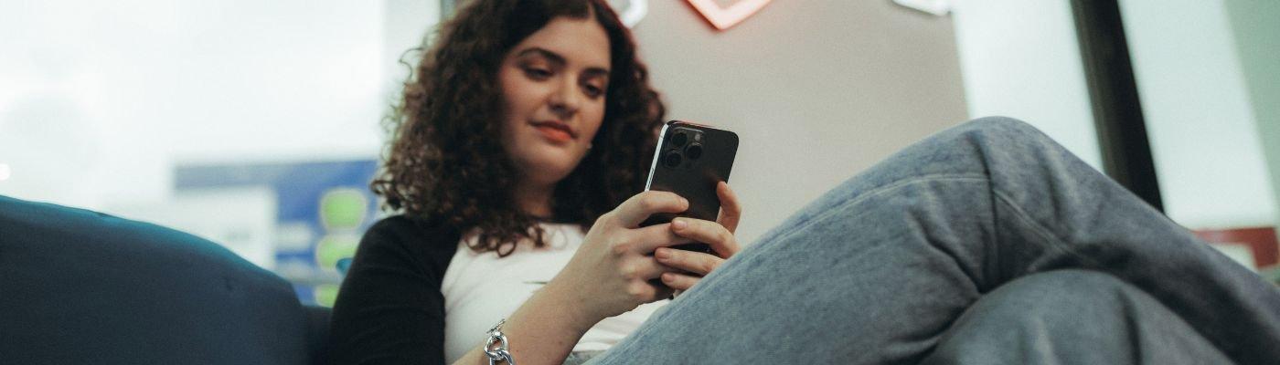 person on their phone to illustrate the process of finding a design tool