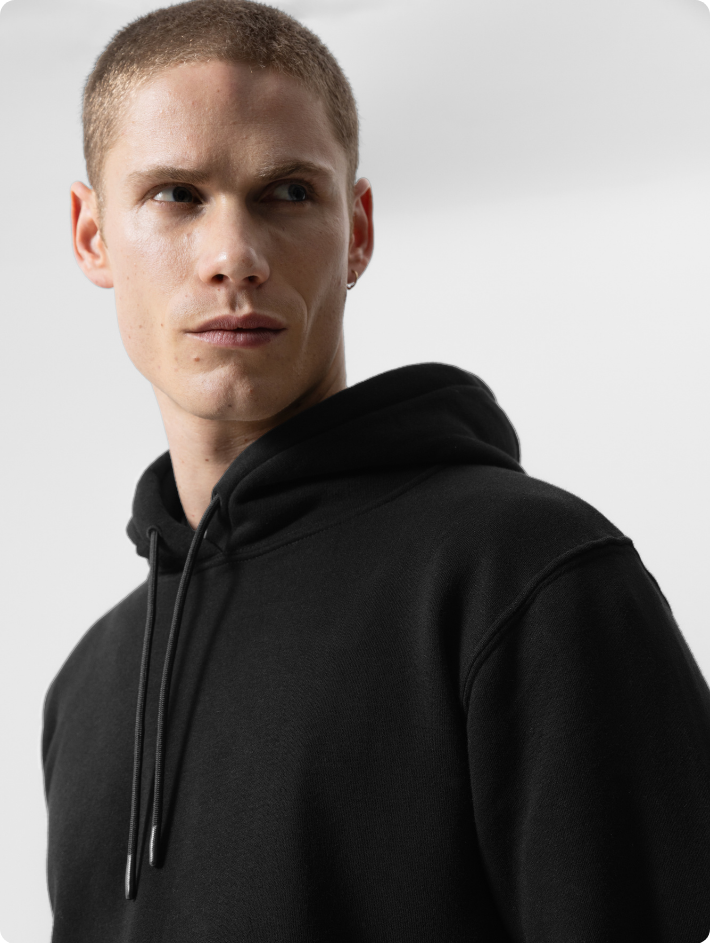 male model wearing black version of mens premium pullover hoodie