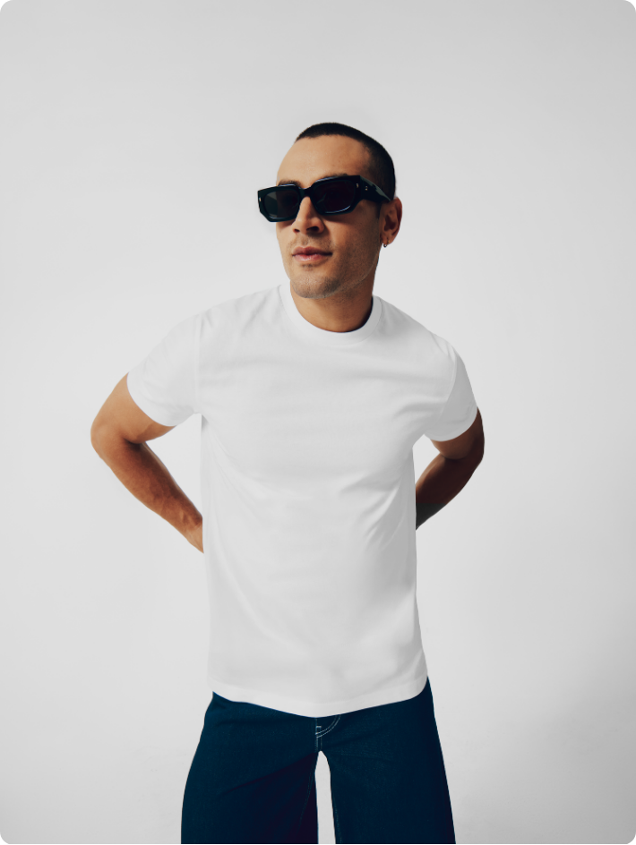 male model wearing white fitted men's premium tshirt in fashion shoot